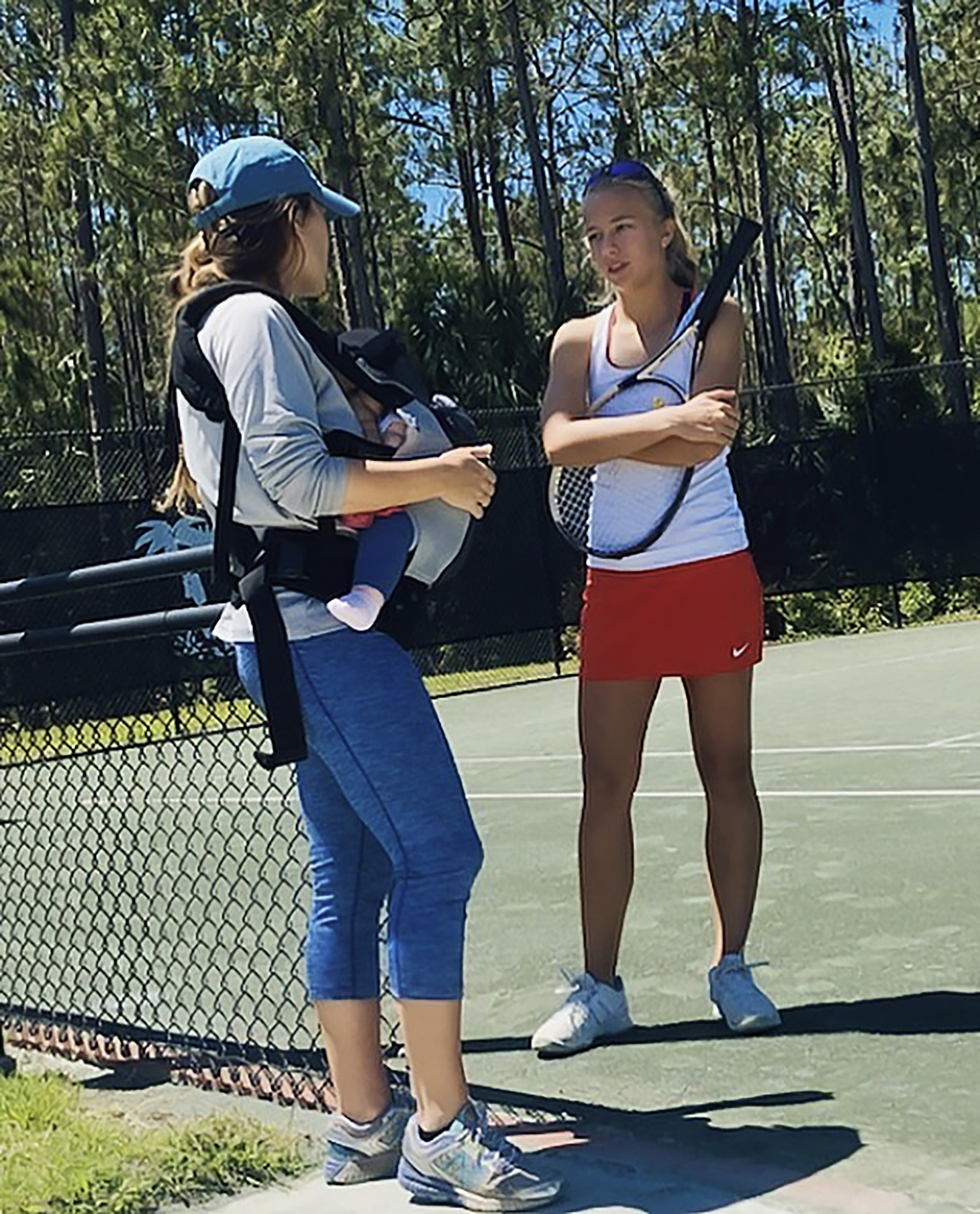 Kimberly Collins discusses strategy with her then tennis coach Jacklyn Gion. Courtesy photo Jacklyn Gion.