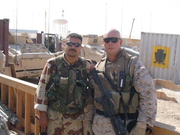 Retired U.S. Marine Corps Sgt. Major Matt Putnam, left, with a Iraqi soldier on the morning before he got shot in 2004. Courtesy photo