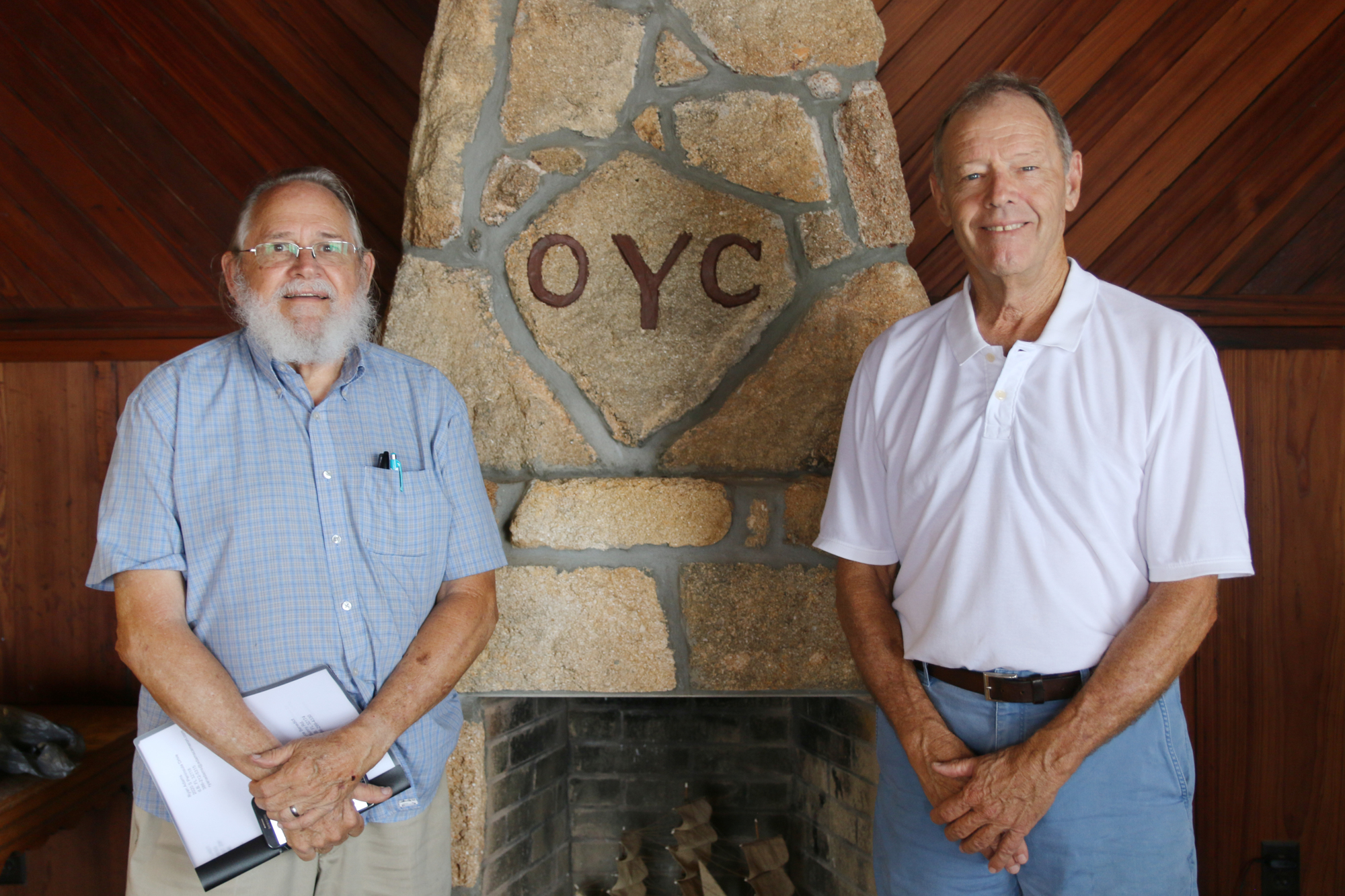 OYC member Bill Partington II and President Kevin Callahan stand by the coquina fireplace, which is anchored to the riverbed and is original to the building. Photo by Jarleene Almenas