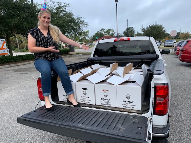 A member of the Rotary Club of Daytona Beach West shows off some of the packed boxes for the club's Thanksgiving Basket Brigade effort. Courtesy photo