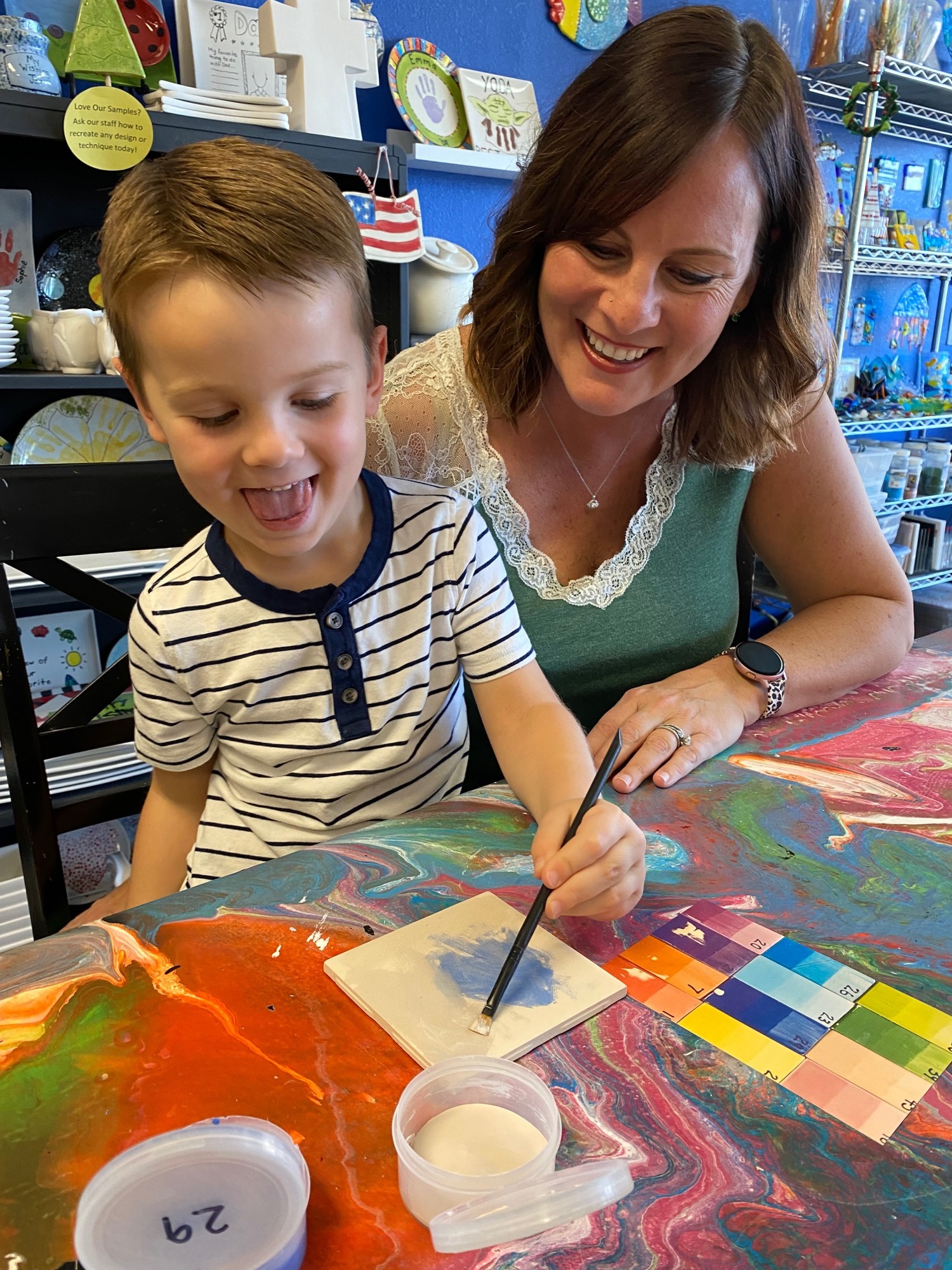 Wyatt and Cat Cordell paint a ceramic tile at Whim Wham Art Studio. Courtesy photo