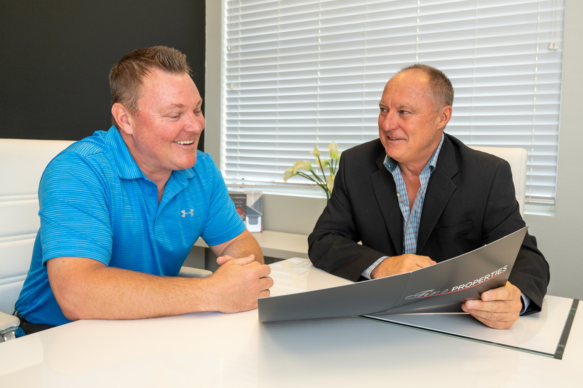 Shaun Peens, left, sits with realtor Jeremy Hartmark at the office in Lakewood Ranch. (Photo by Lori Sax)