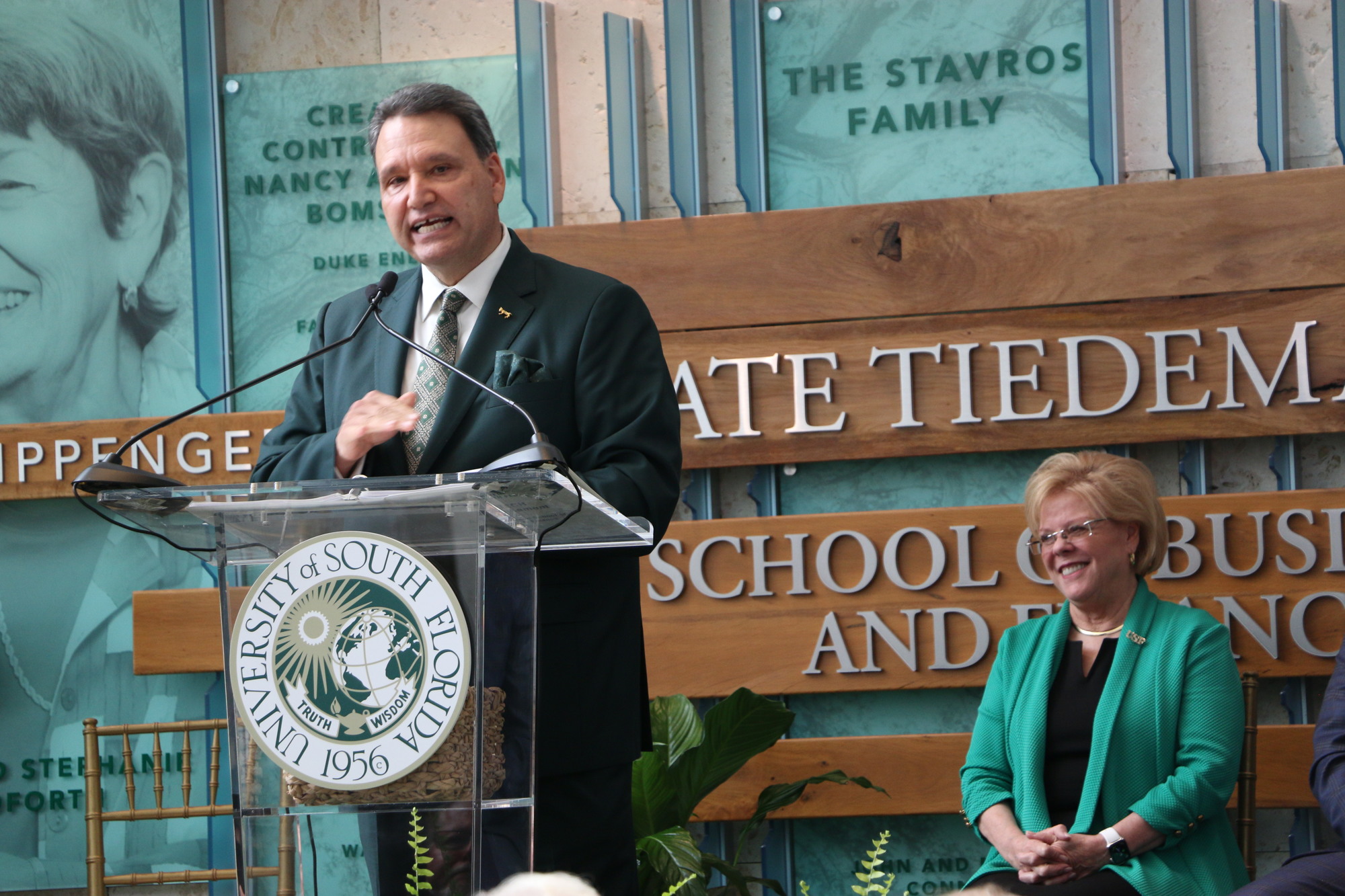 Courtesy. USF Muma College of Business Dean Moez Limayem, at lectern, and USF President Rhea Law announce the $14 million gift from Kate Tiedemann and Ellen Cotton.