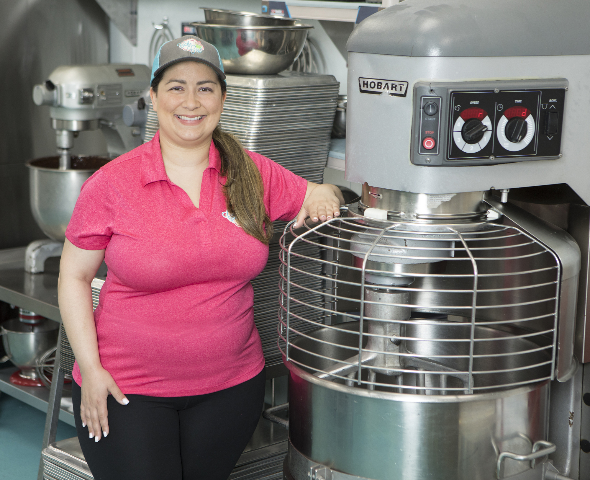 Mark Wemple. Kristina Lavallee shows off the bakery's new 140-quart mixer.