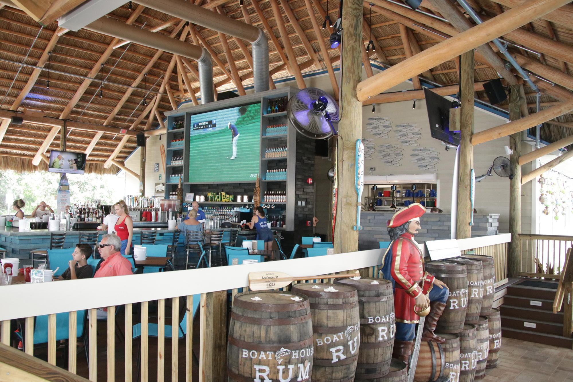 The 12-by-8-foot TV anchors the main dining and bar area.