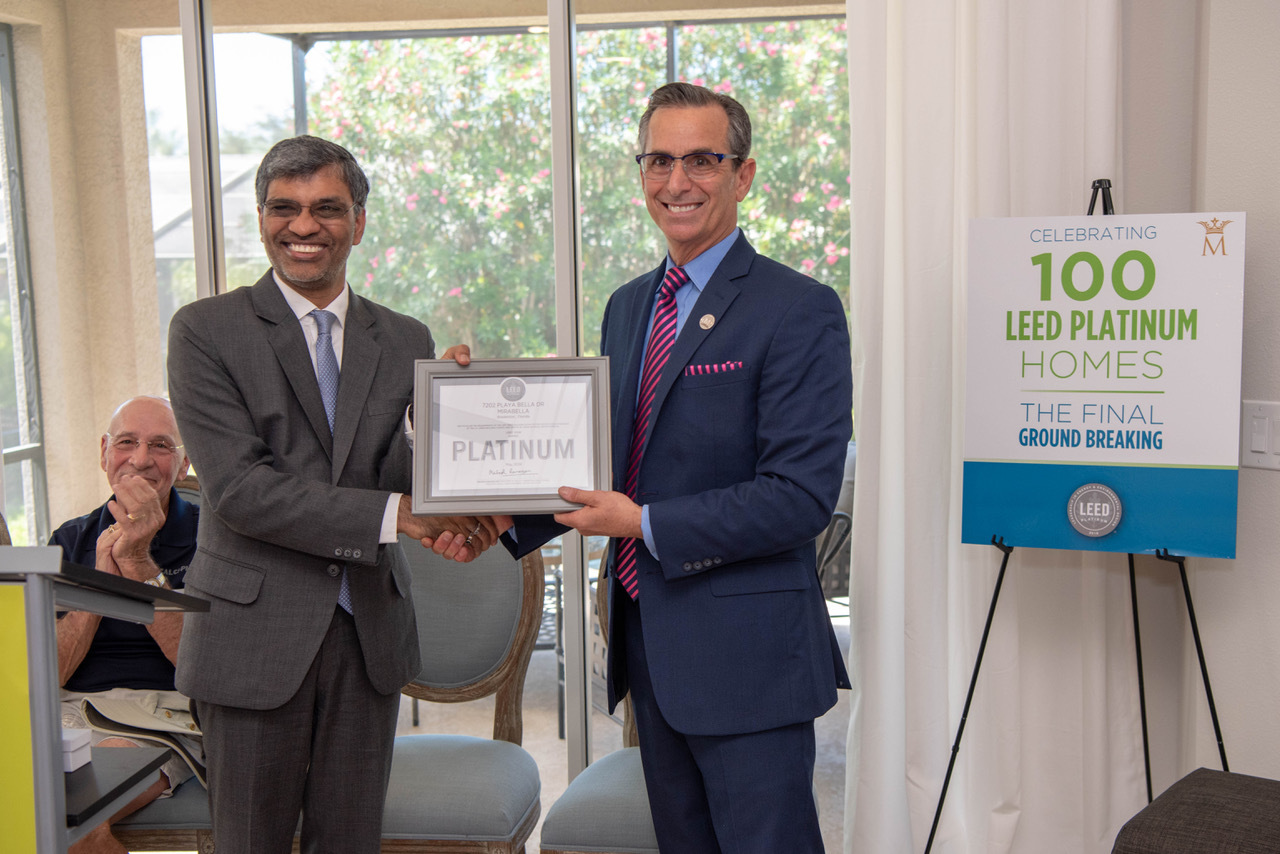 Mahesh Ramanujam, U.S. Green Building Council president and CEO, presenting Marshall Gobuty with Mirabella's 100th LEED Platinum Certification.