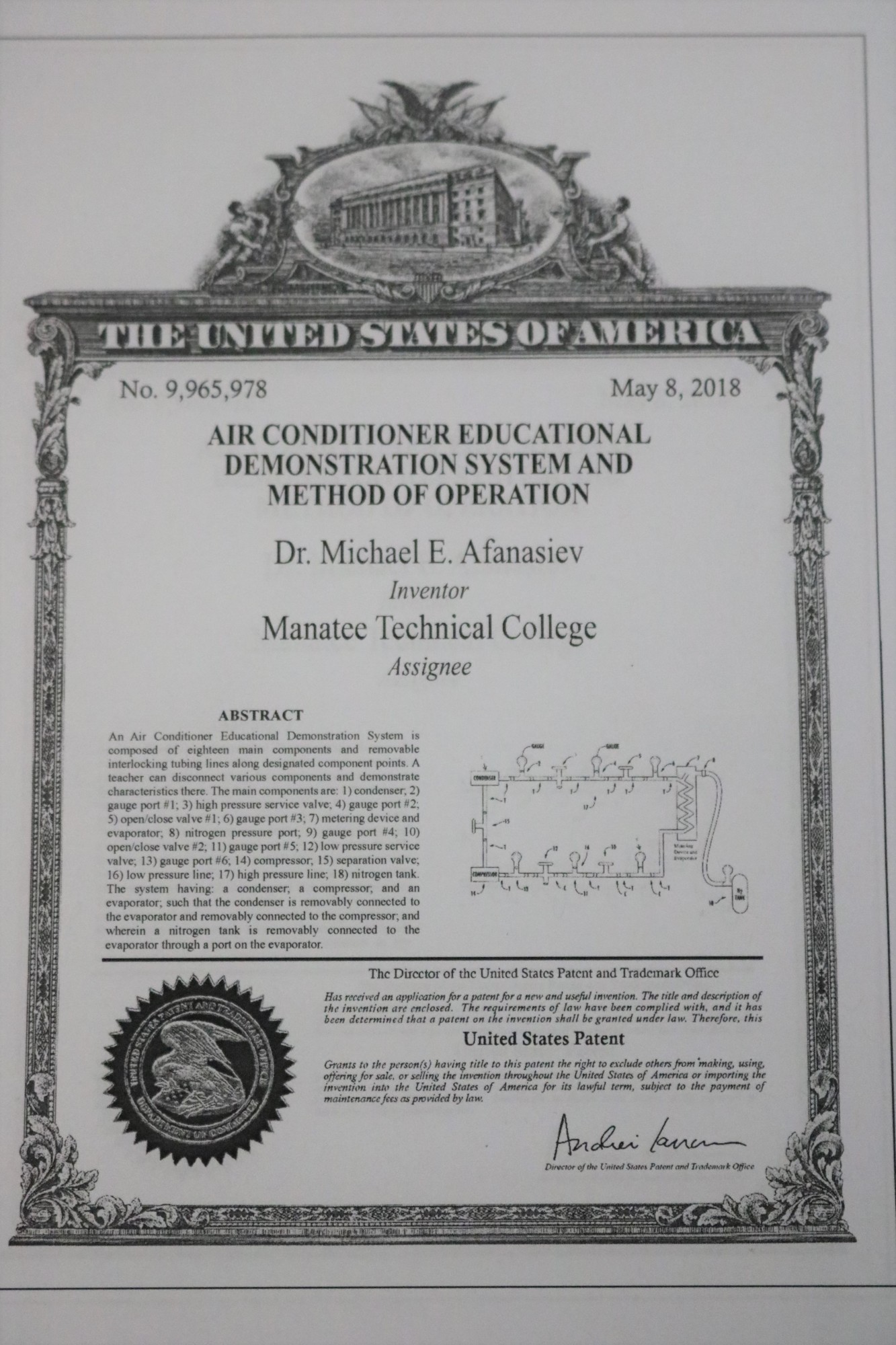 A photograph of the patent for Michael Afanasiev's invention, assigned to Manatee Technical College.