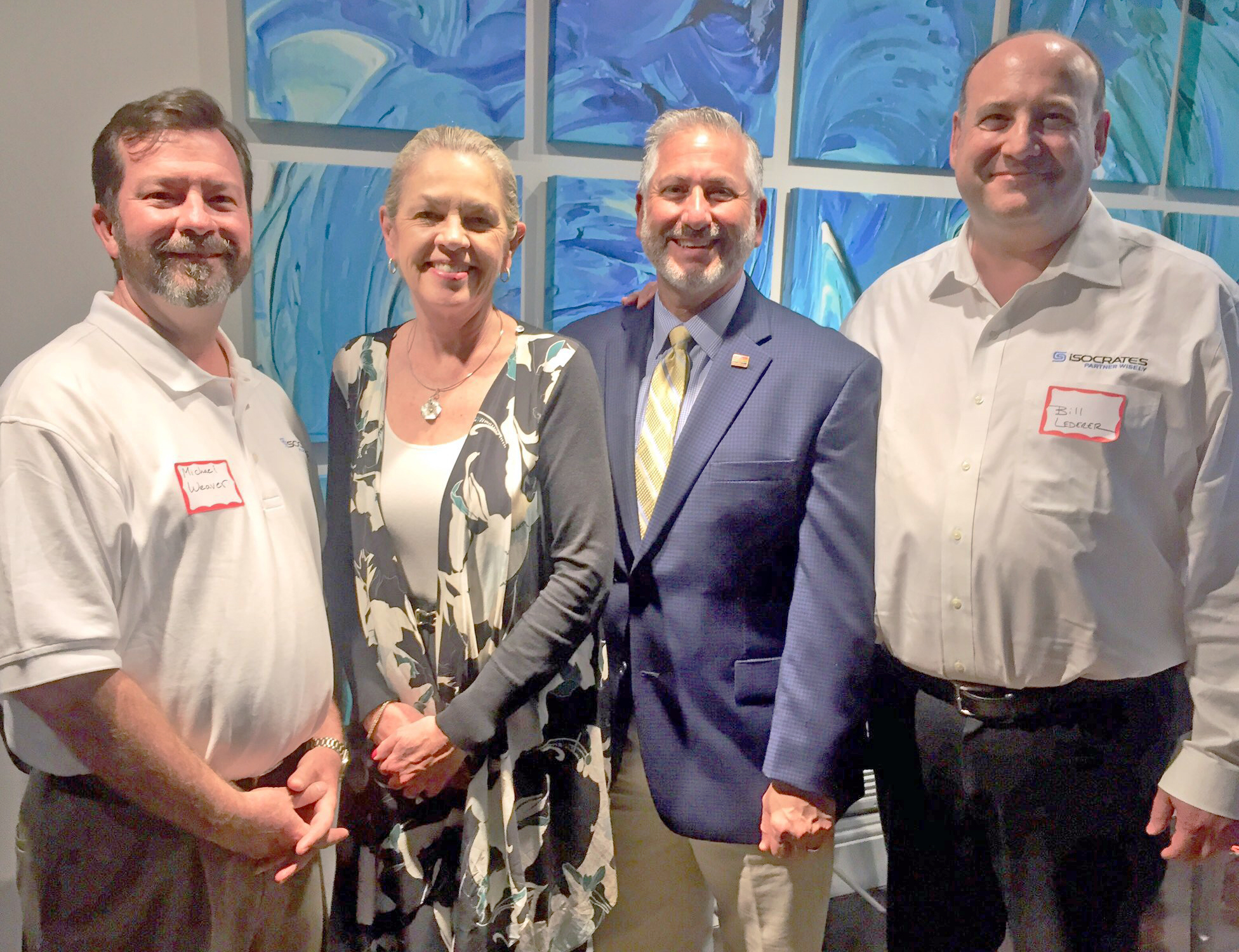 iSocrates executives Michael Weaver, far left, and Bill Lederer, far right, were welcomed to St. Petersburg by Mayor Rick Kriseman and Pinellas County Commissioner Karen Seel. Courtesy photo.