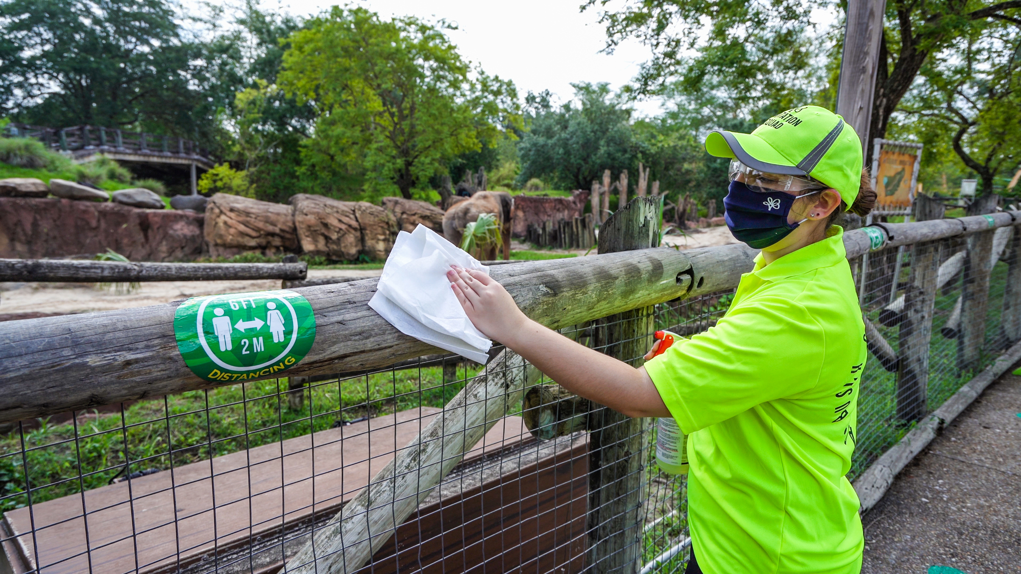 Courtesy. A Busch Gardens' sanitation squad member cleans an animal environment.