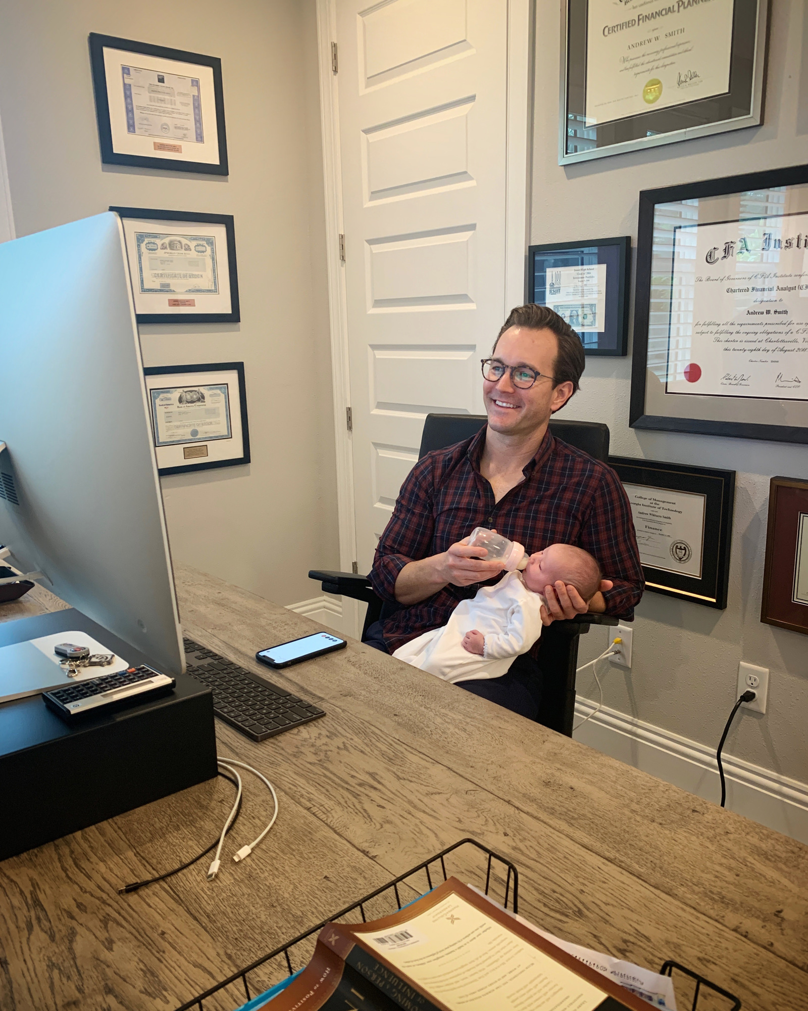 Courtesy. Andrew Smith cares for his infant daughter in his home office.