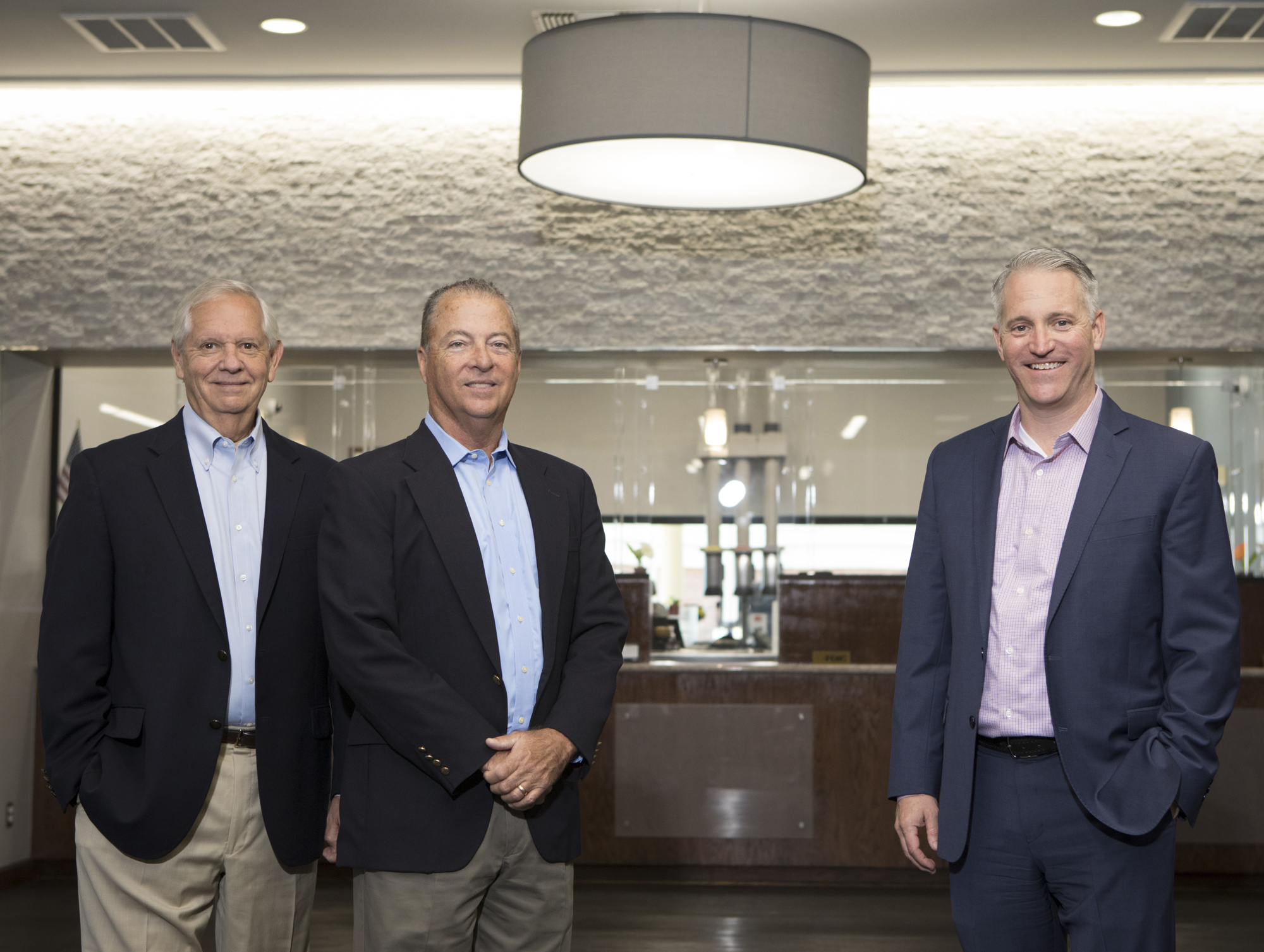 The Bank of Tampa's Bill West, left, and Corey Neil, far right, are looking forward to the merger with Hillsboro Bank, overseen by Mike Ward, middle.