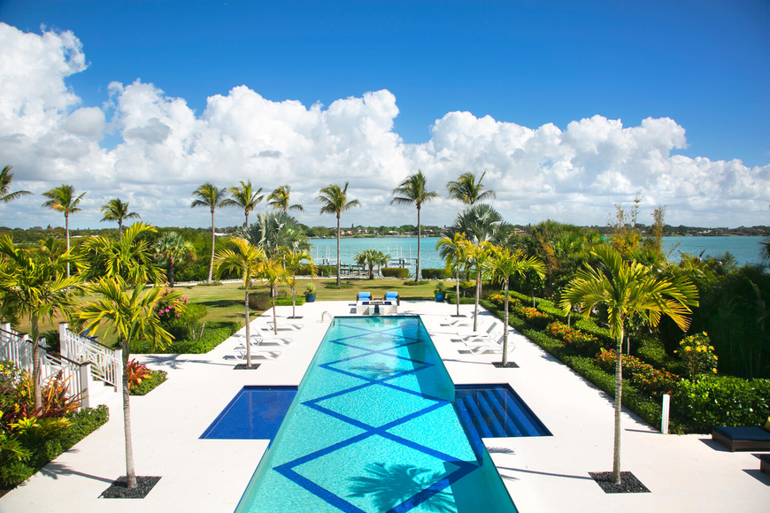 The swimming pool overlooks the water.