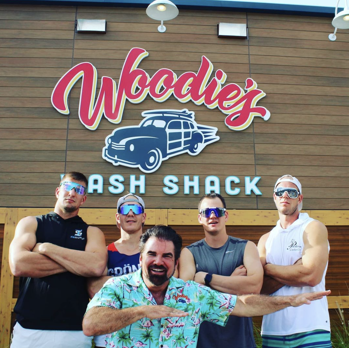 Courtesy. Woodie's Wash Shack Managing Partner Don Phillips with Bucs star Rob Gronkowski and his brothers.