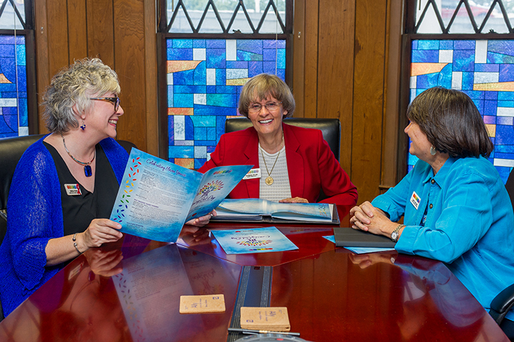 Barbara Russell Drake, center, is board treasurer for JASMYN, the Jacksonville Sexual Minority Youth Network. She works closely with Development Officer Angela Strain, left, and CEO Cindy Watson. A local bank provided the stick-on