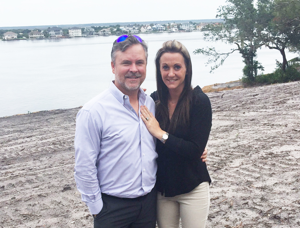 Summit Contracting Group Inc. owners Marc and Nicole Padgett stand on the site of their new home in the Fort Caroline area of Arlington.