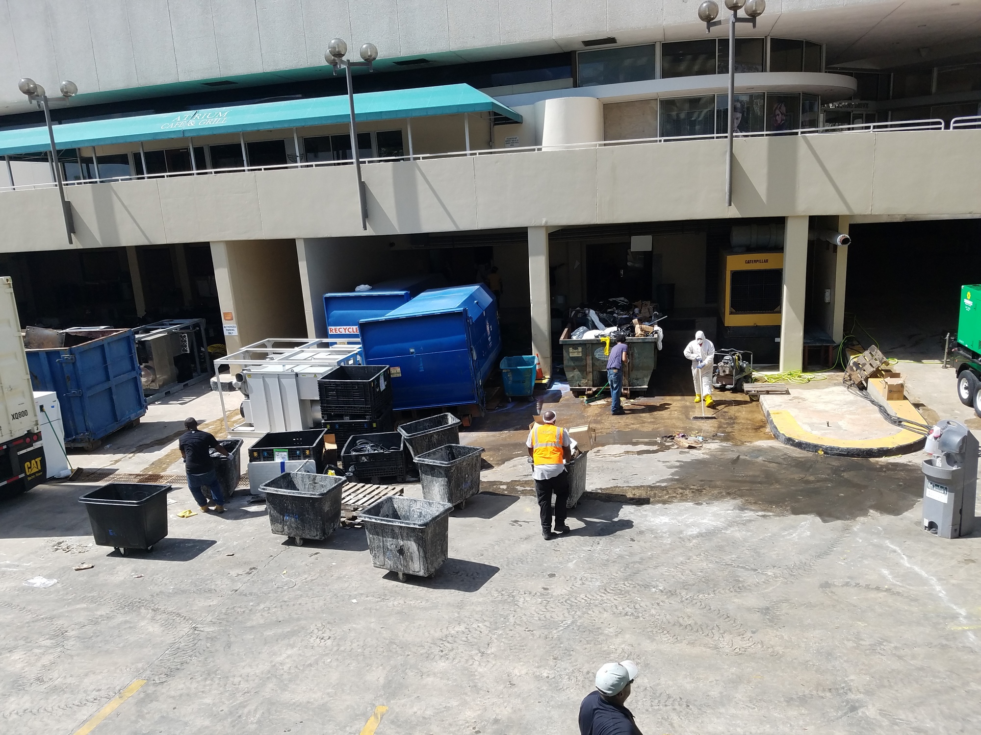 Workers remove debris from the basement on the Wells Fargo Center on Tuesday. The building is expected to reopen Wednesday.