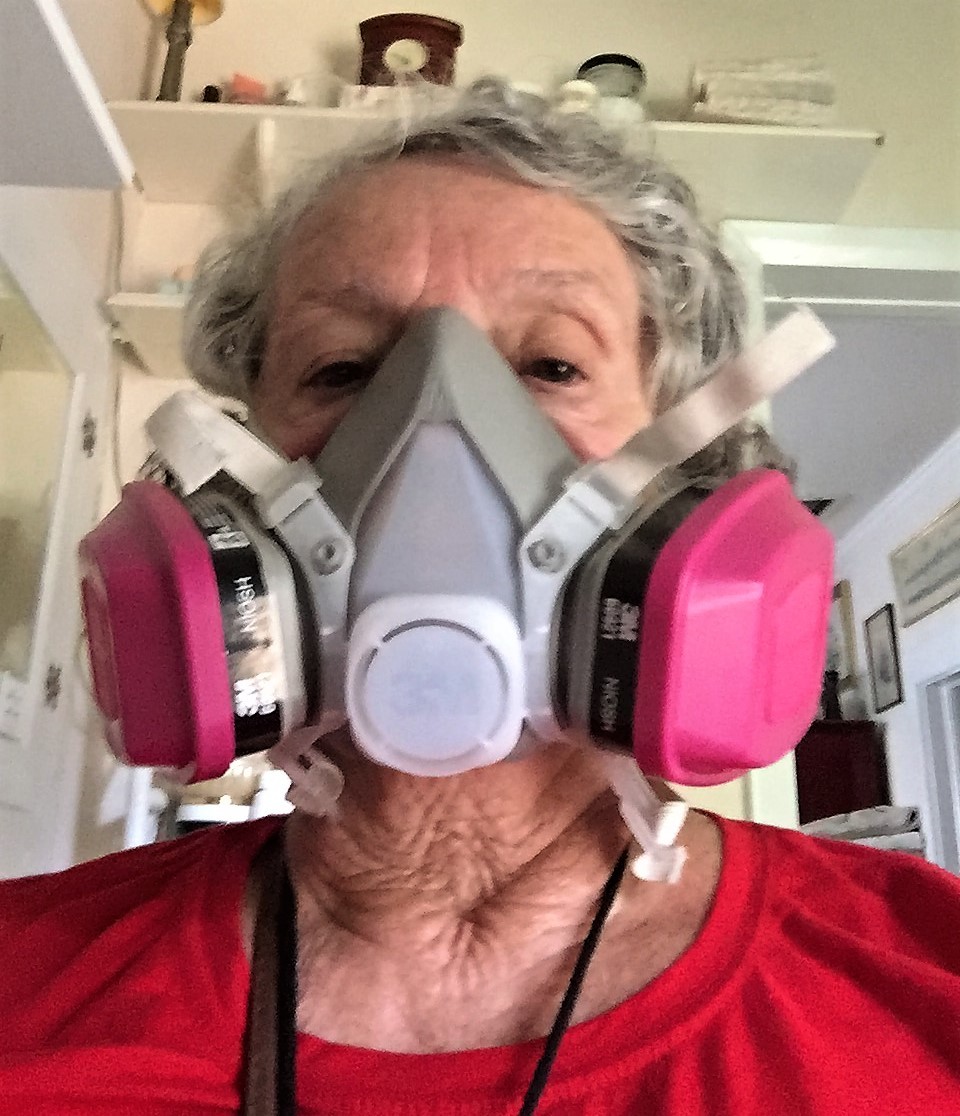 To protect herself from mold and mildew, Arnold used a respirator mask to inspect the inside of her home with adjusters from FEMA and State Farm insurance.