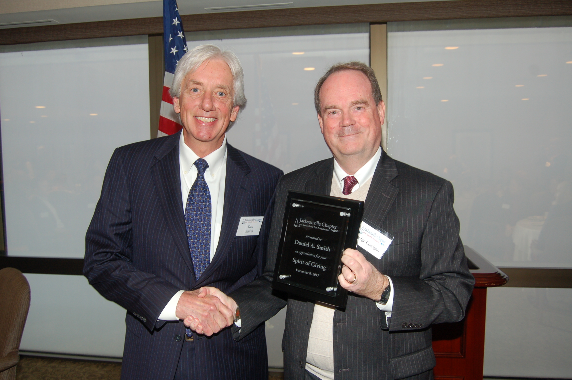 U.S. District Judge Timothy Corrigan, right, presented the Jacksonville Chapter of the Federal Bar Association’s 2017 Spirit of Giving Award to attorney Daniel Smith.