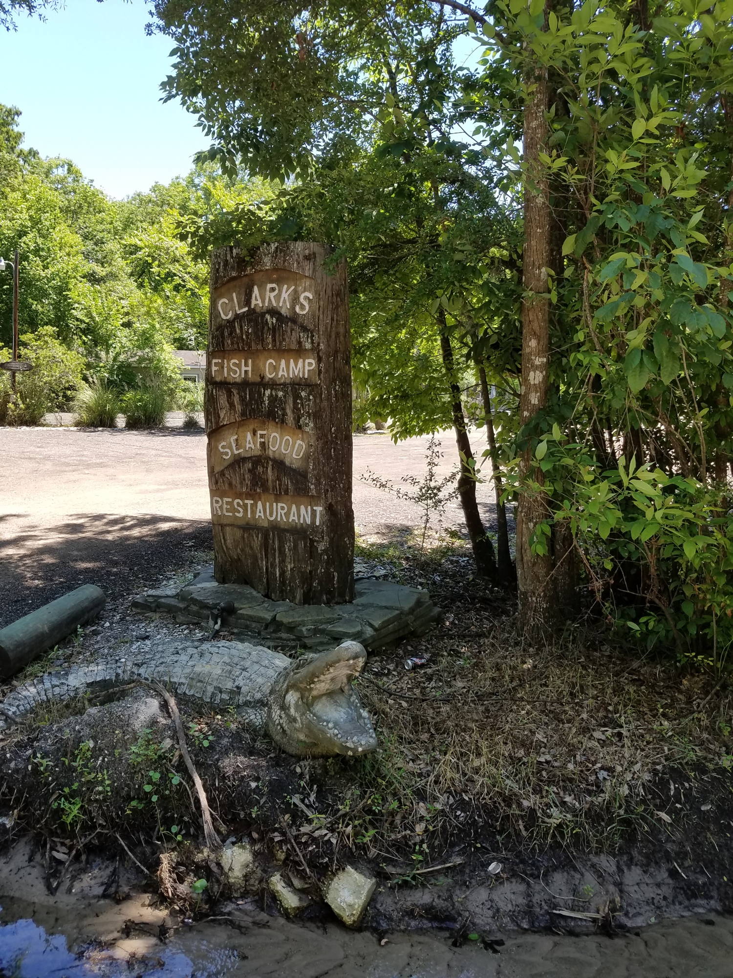 An alligator — statue — guards the entrance to Clark’s Fish Camp in Mandarin. The restaurant filed for a Chapter 11 bankruptcy restructuring last week.