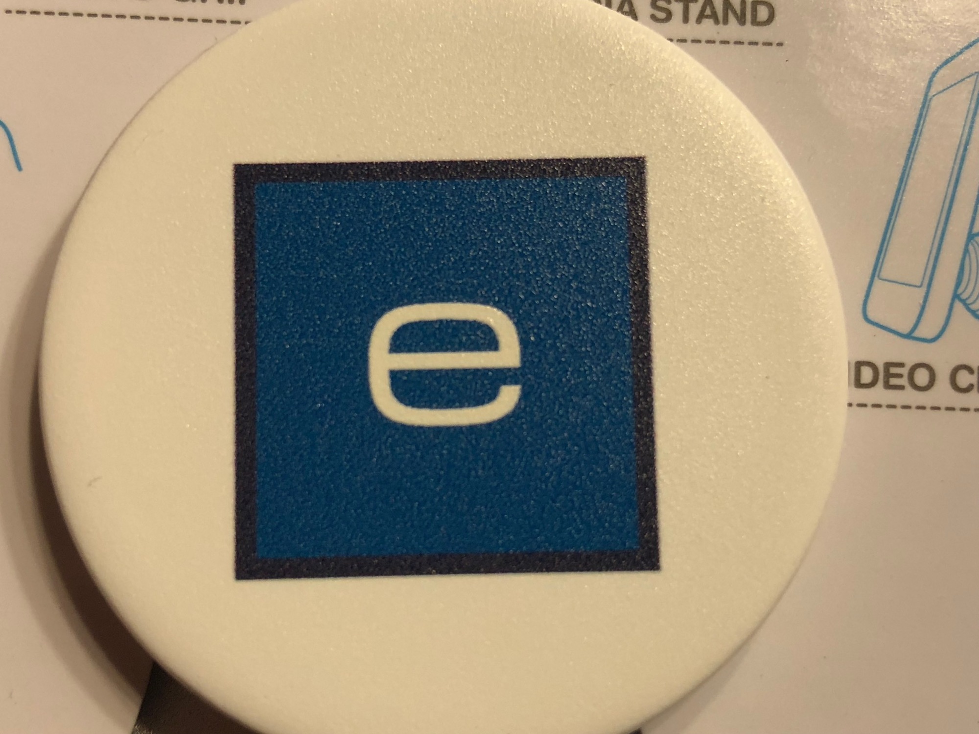 A Popsockets mobile phone accessory features the eTown logo.