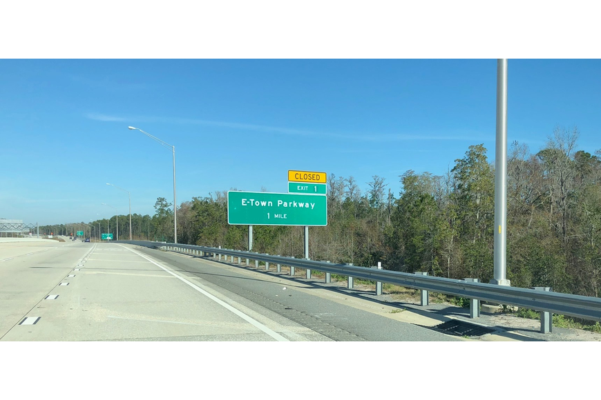 A sign for eTown can be seen while driving along Florida 9B.