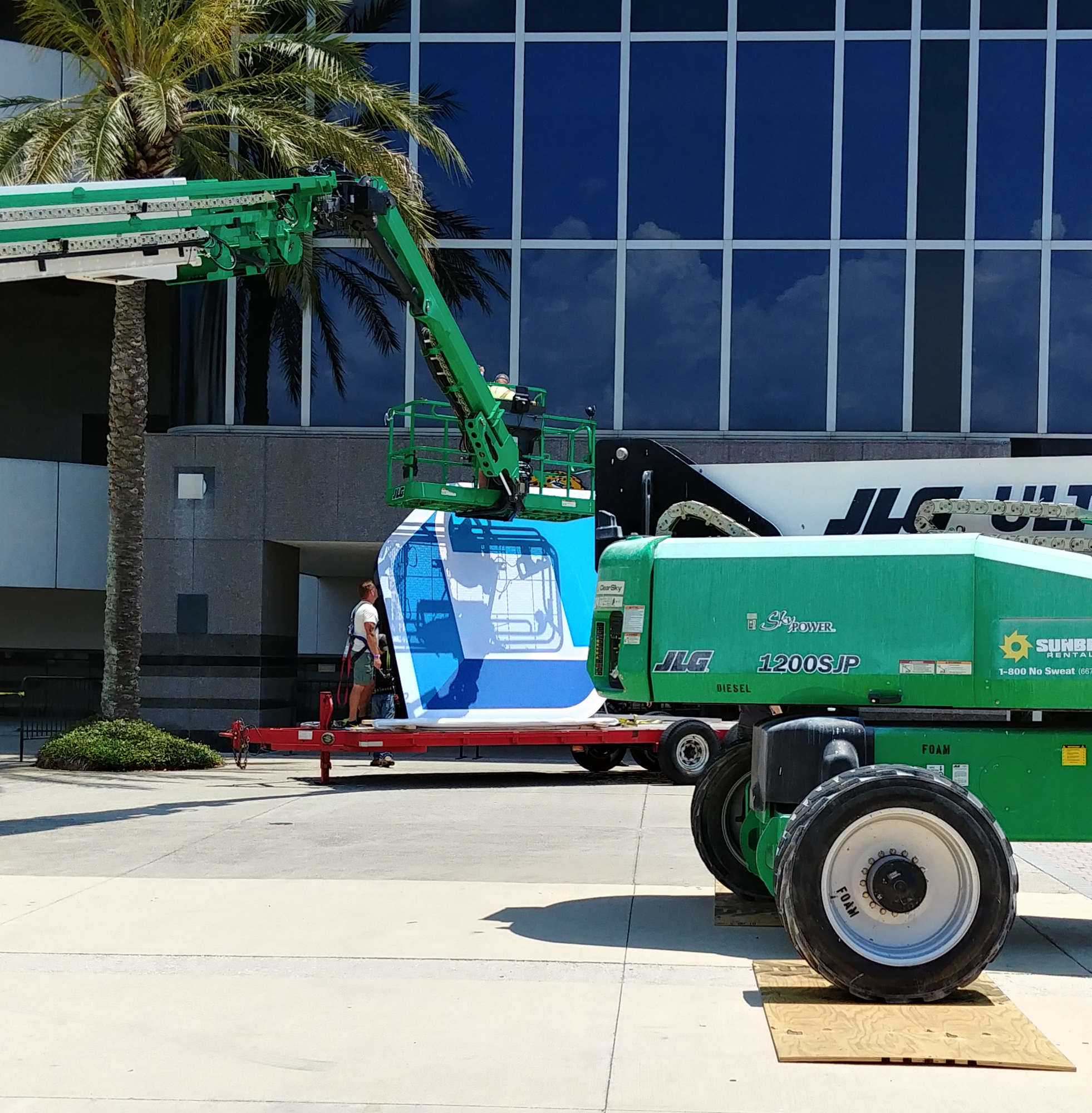 The TIAA Bank logo is prepared to be hoisted into position.