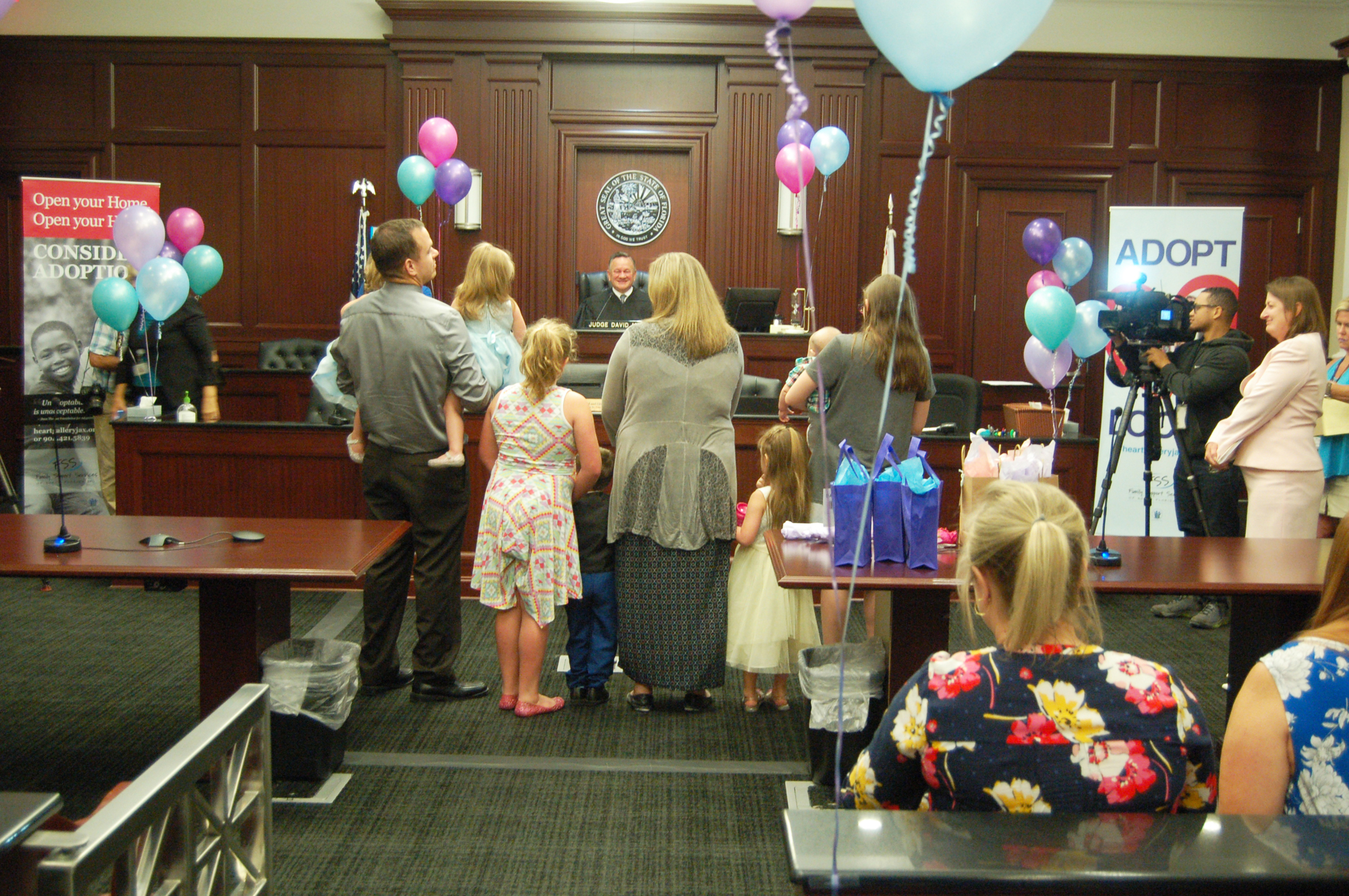 Four families grew Friday when Circuit Judge David Gooding signed adoption decrees at the annual pre-Mother’s Day adoption hearing. Of the nearly 300 adoptions he conducts each year, 99 percent involve Guardian ad Litem.
