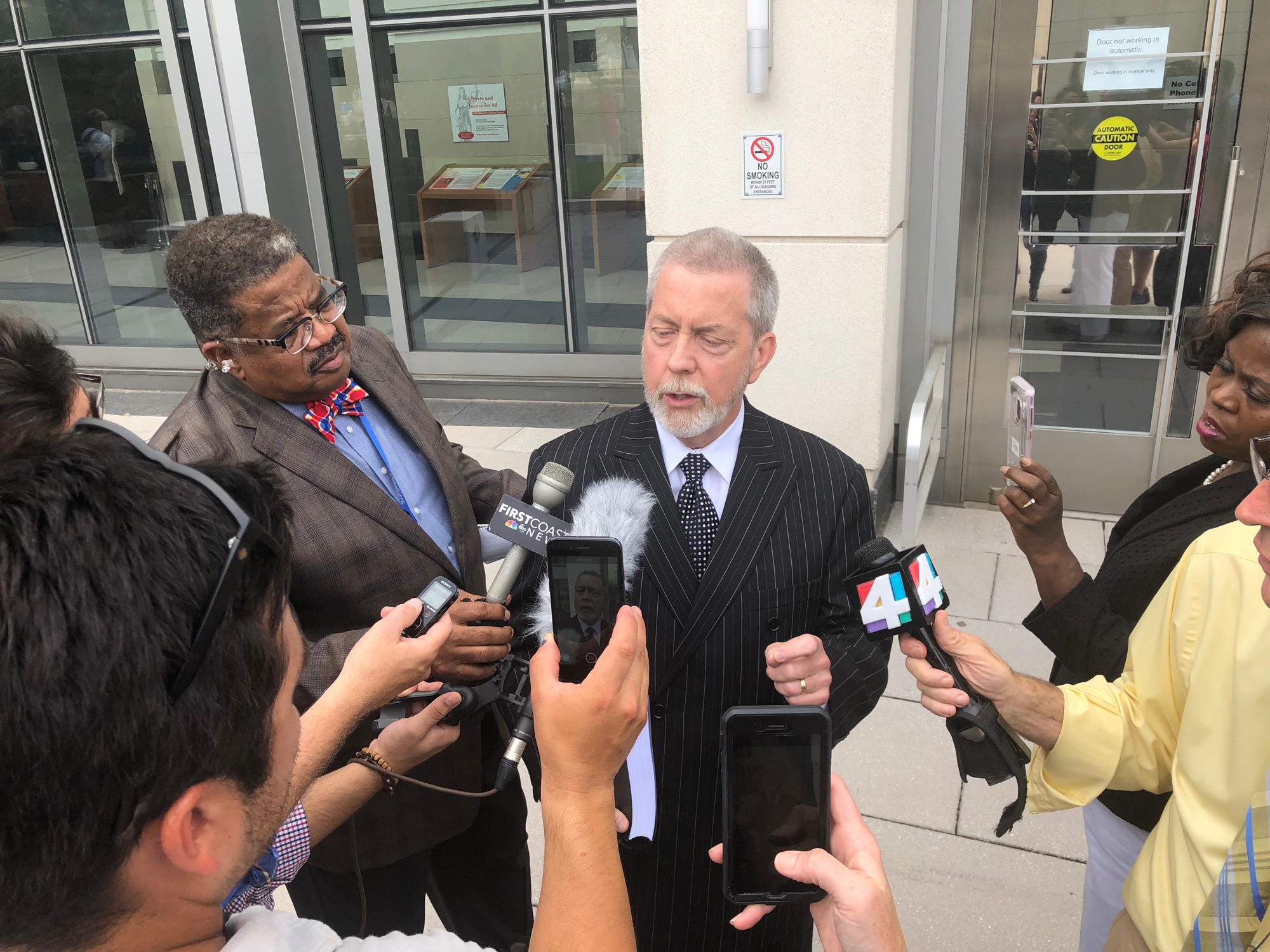 Curtis Fallgatter, the attorney for council member Katrina Brown, talks to reporters outside the Bryan Simpson U.S. Courthouse on Thursday.