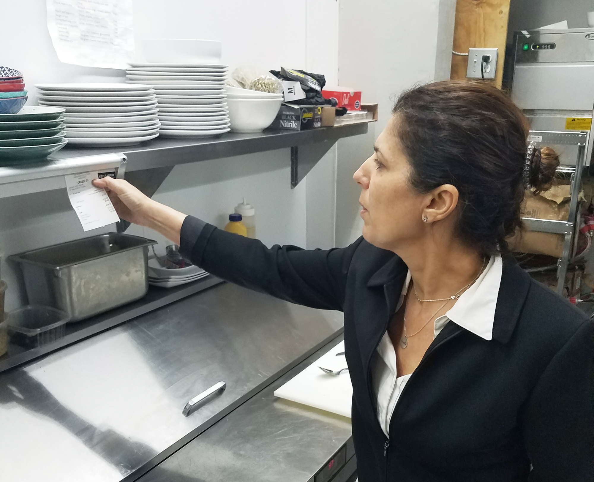 Ricki Ben Simon, who practices Orthodox Judaism,  oversees the accuracy of an order in the kitchen of her new restaurant.