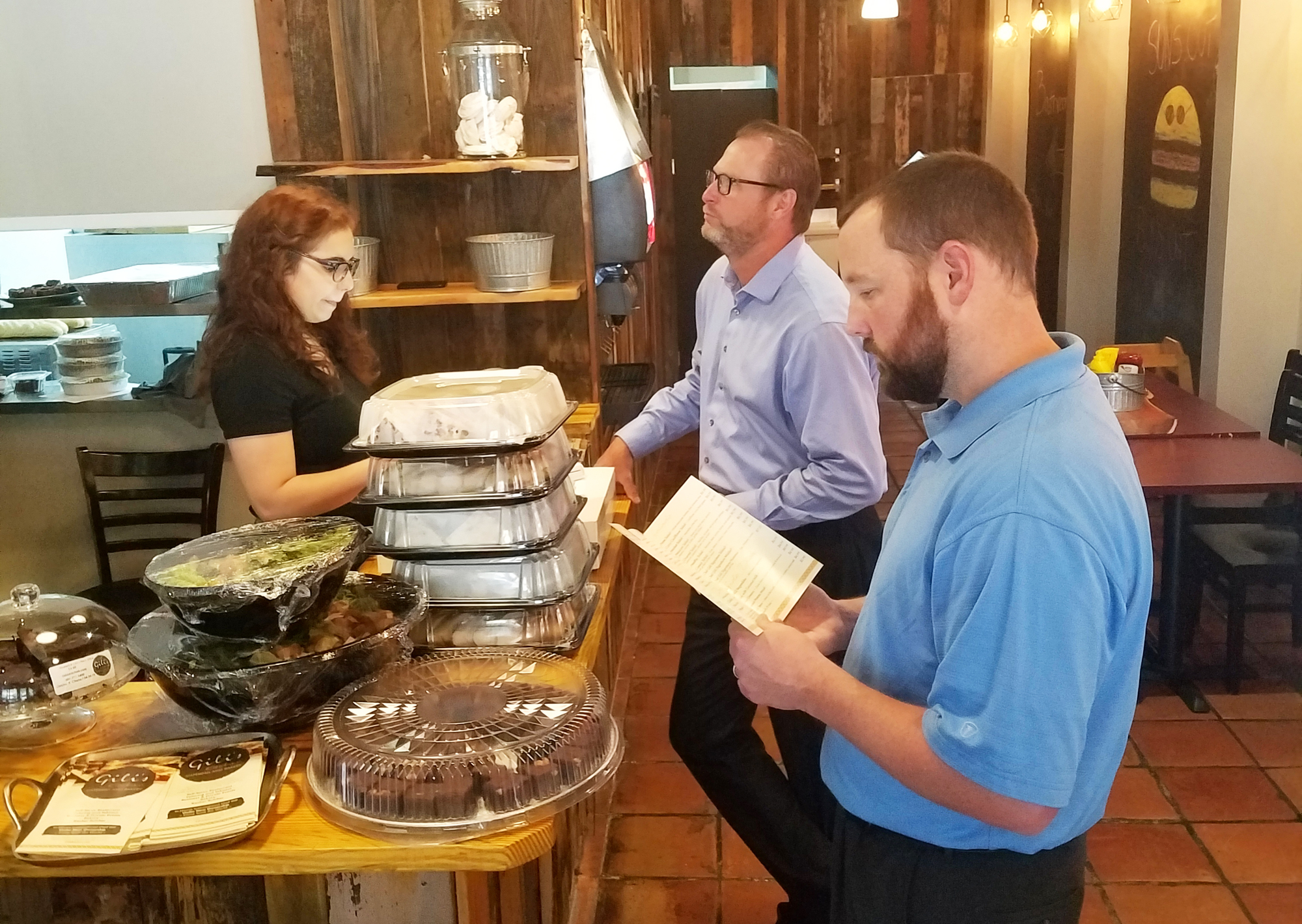 Elly Ben Simon of Gili’s Kitchen takes orders from customers Brian Griner and Justin Jennings in the new Downtown restaurant at 126 W. Adams St. that features kosher preparation of international and American cuisine.