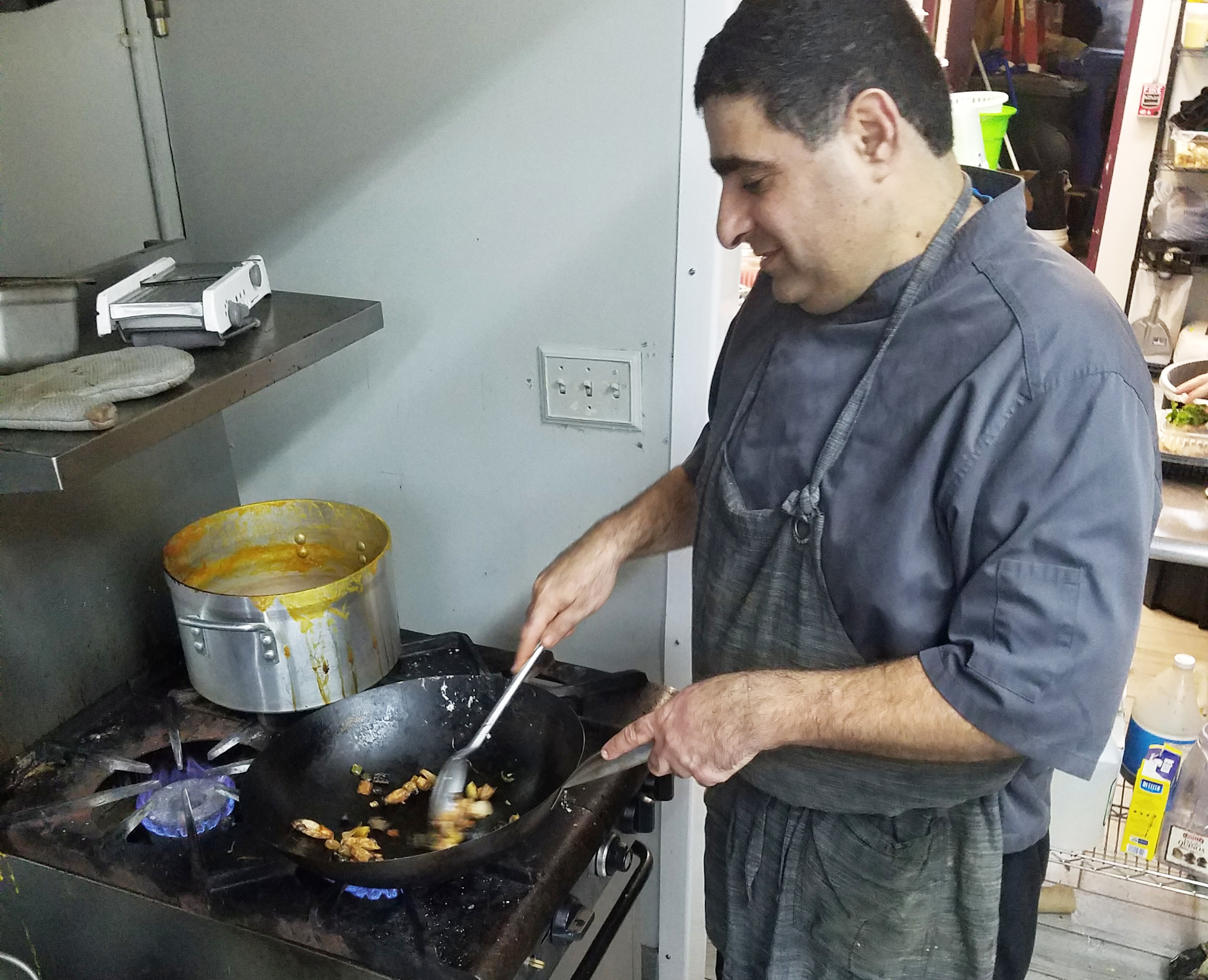 Head chef Gili Ben Simon prepares a kosher dish at the restaurant named after him, Gili’s Kitchen Catering and Bakery.