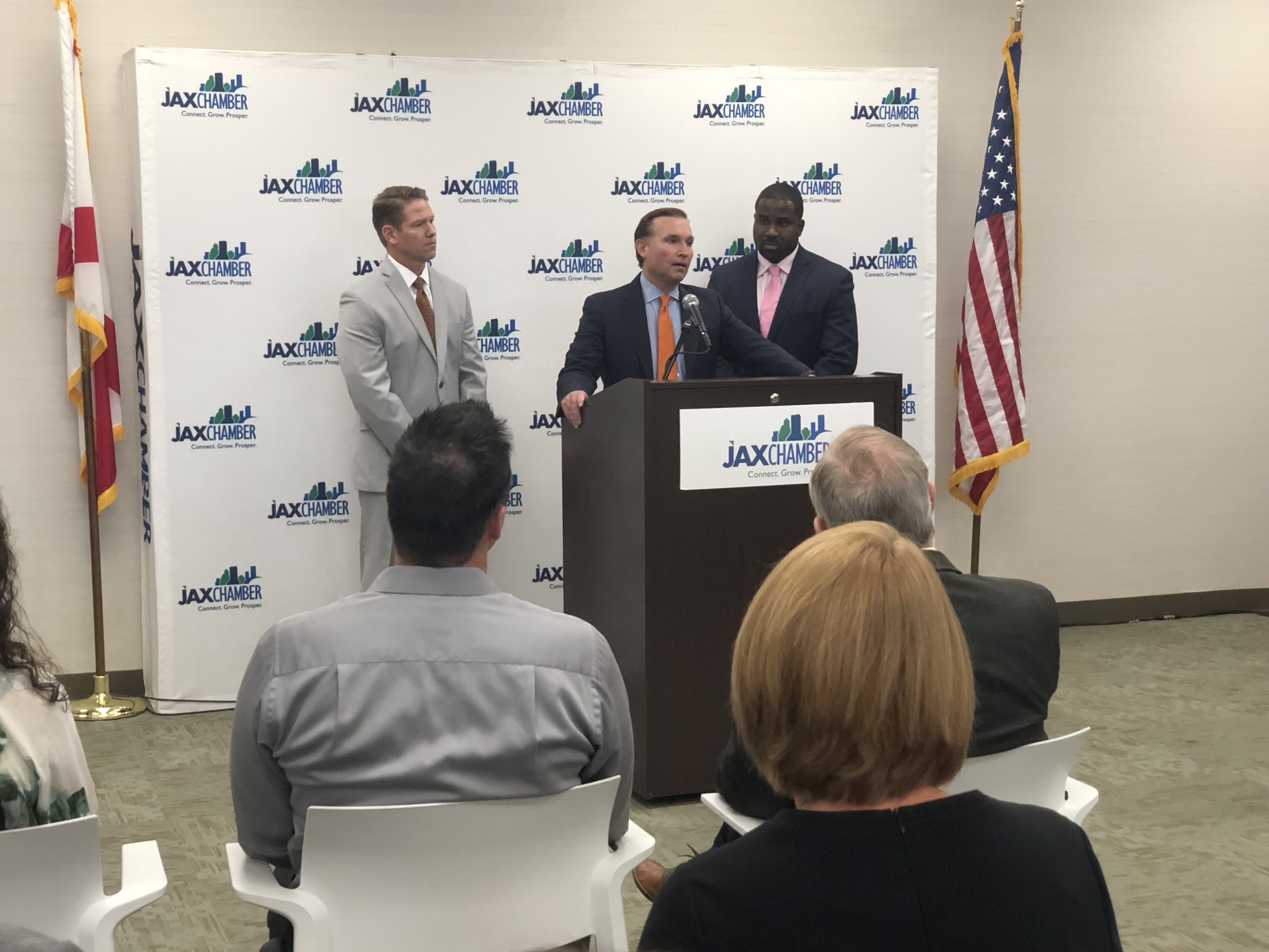 Mayor Lenny Curry, flanked by JAX Chamber President Daniel Davis, left, and Dane Grey, JAXBIZ board chair, accepts the endorsement of JAXBIZ.