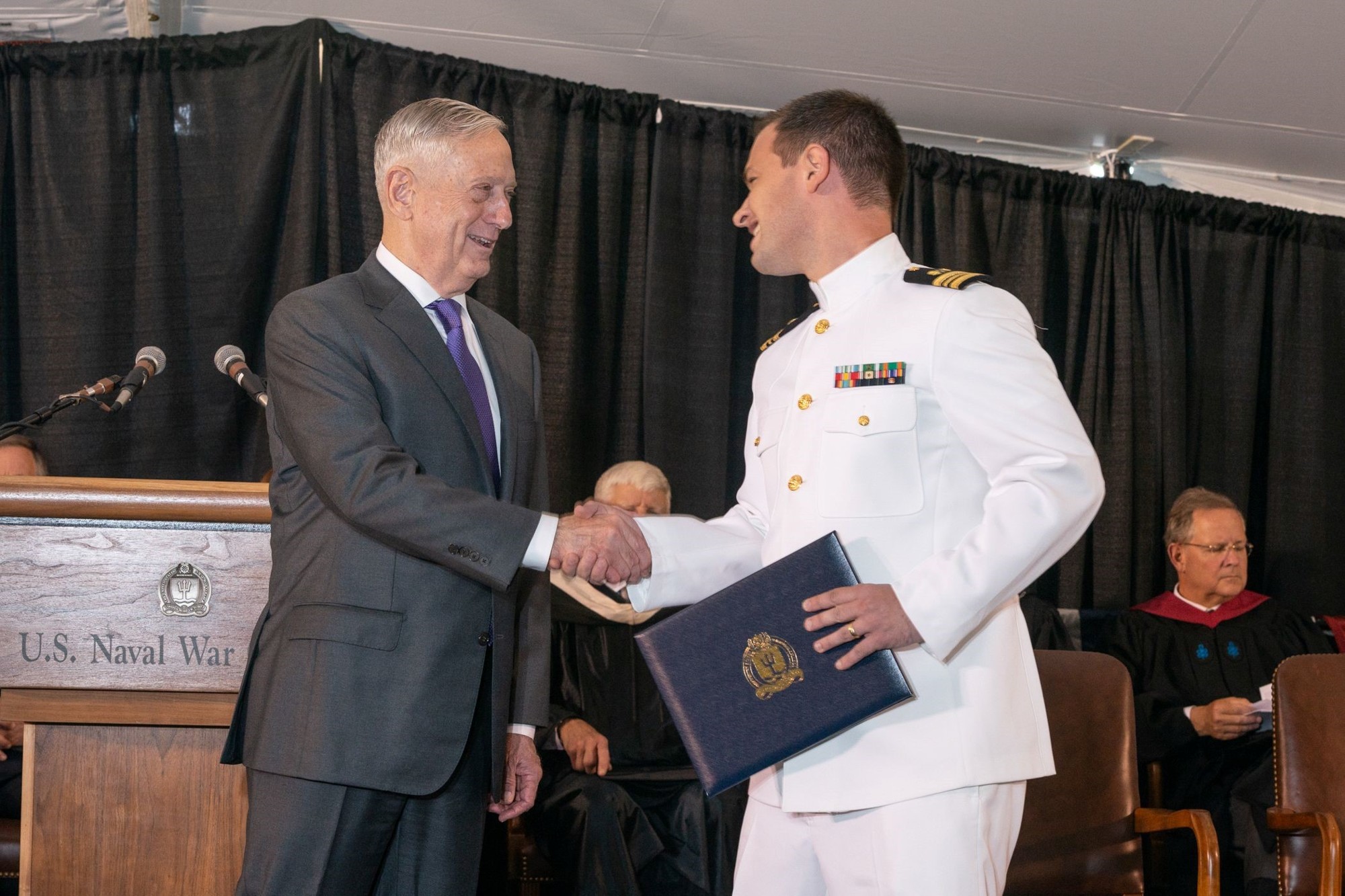 Secretary of Defense James Mattis congratulates Rogers Towers litigator Adam Brandon.