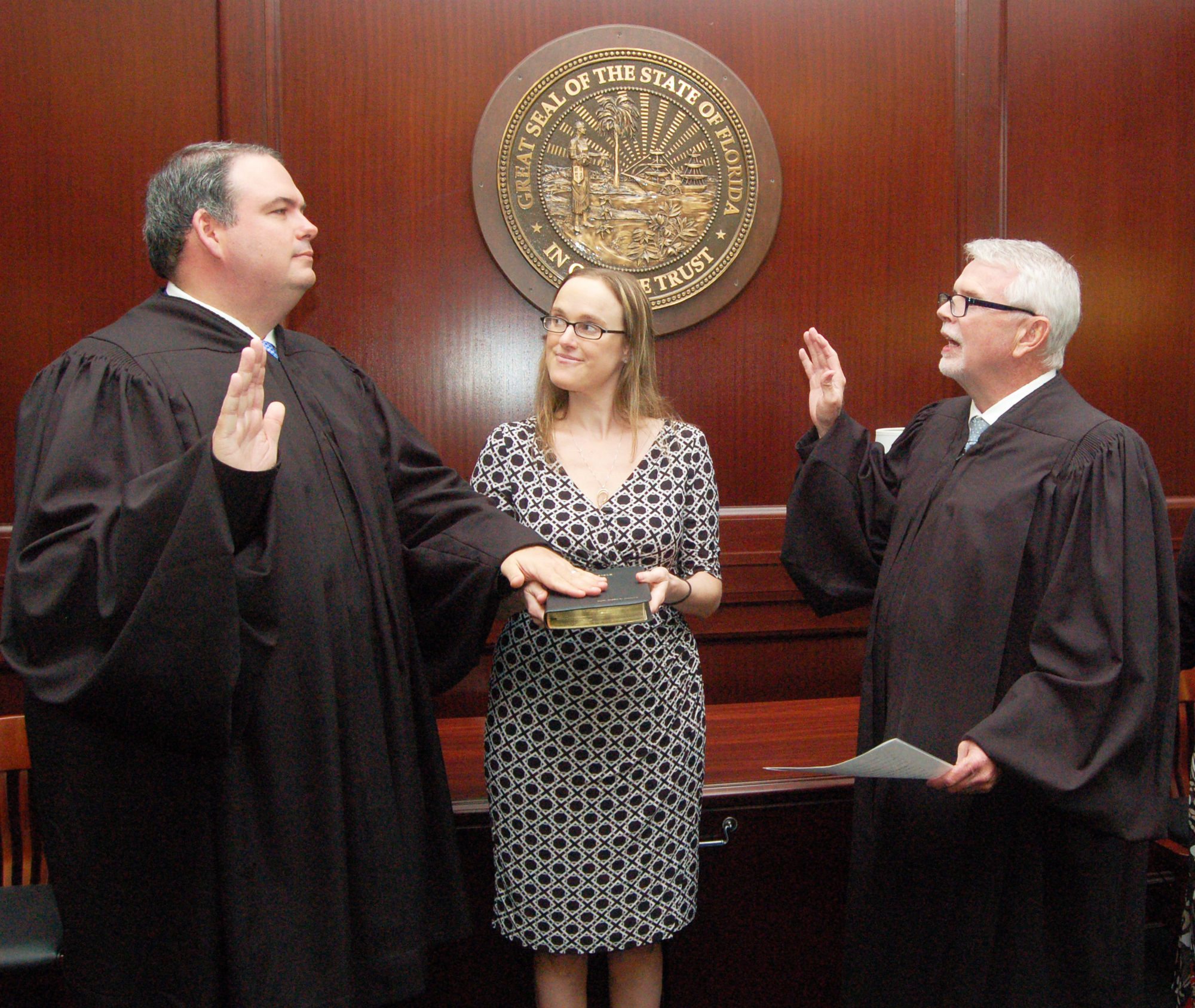 Helen Peacock Roberson holds the Bible as her husband, Circuit Judge Eric Roberson, left, is sworn in by Chief Judge Mark Mahon.