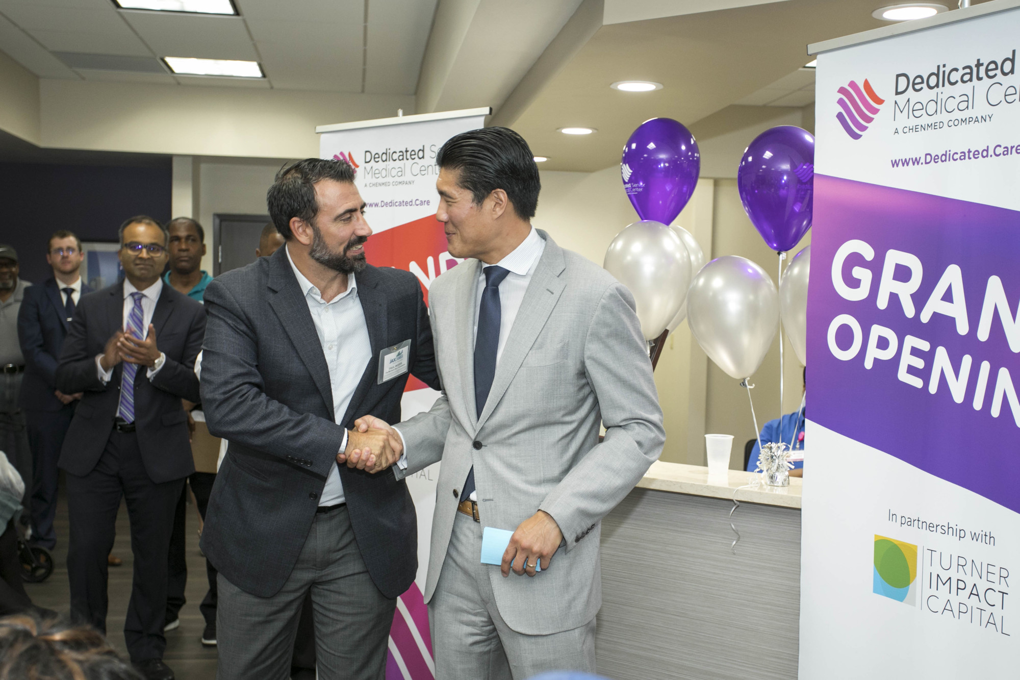 JAX Chamber representative Paul Woods greets ChenMed CEO Christopher Chen at the ribbon-cutting Thursday of the first of three ChenMed Dedicated Senior Medical Centers in Jacksonville.