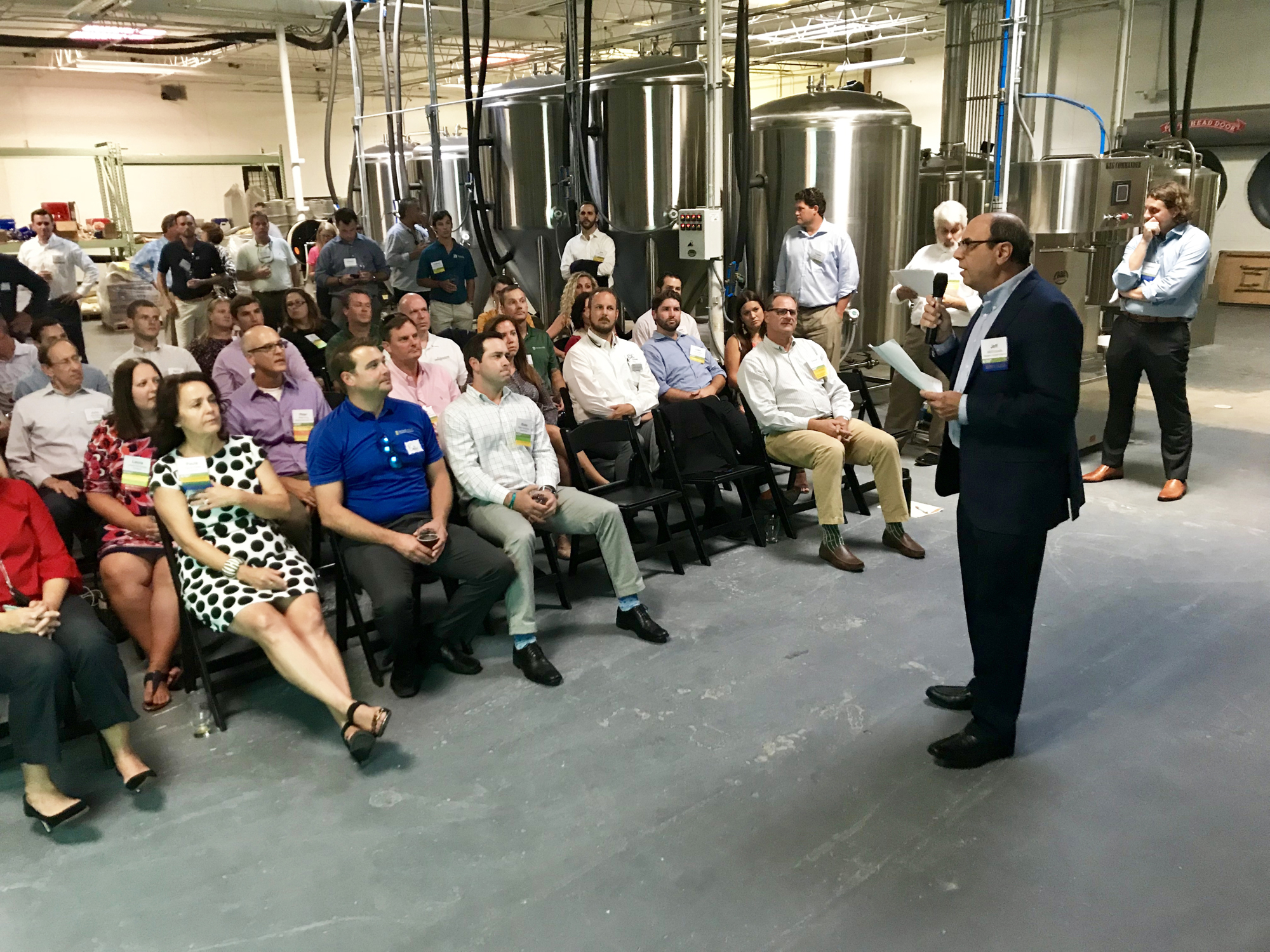 Jeff Edwards, right, shares details about the Rail Yard District Business Council during a meeting of the Urban Land Institute at Tabula Rasa Brewing, a new business that had its grand opening Sept. 14.