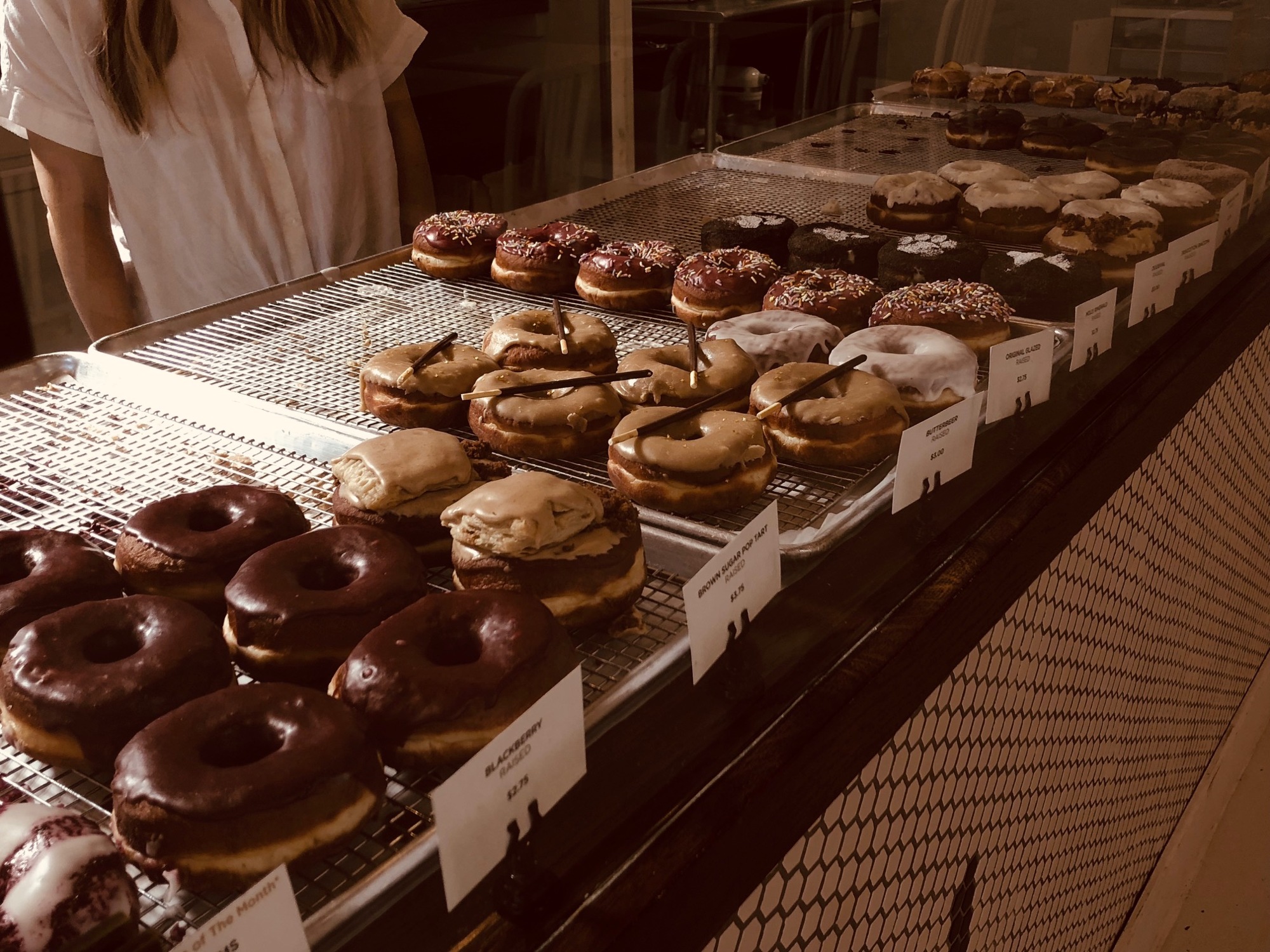 Specialty doughnuts include brown butter, butterscotch bacon, original glazed, Molly Ringwald, Duuuval, Schrute Farms and others.