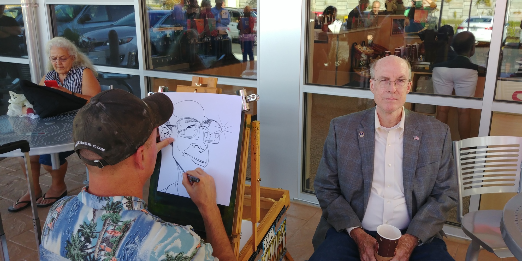 Jacksonville City Council member Matt Schellenberg sits for a caricature at the grand opening.