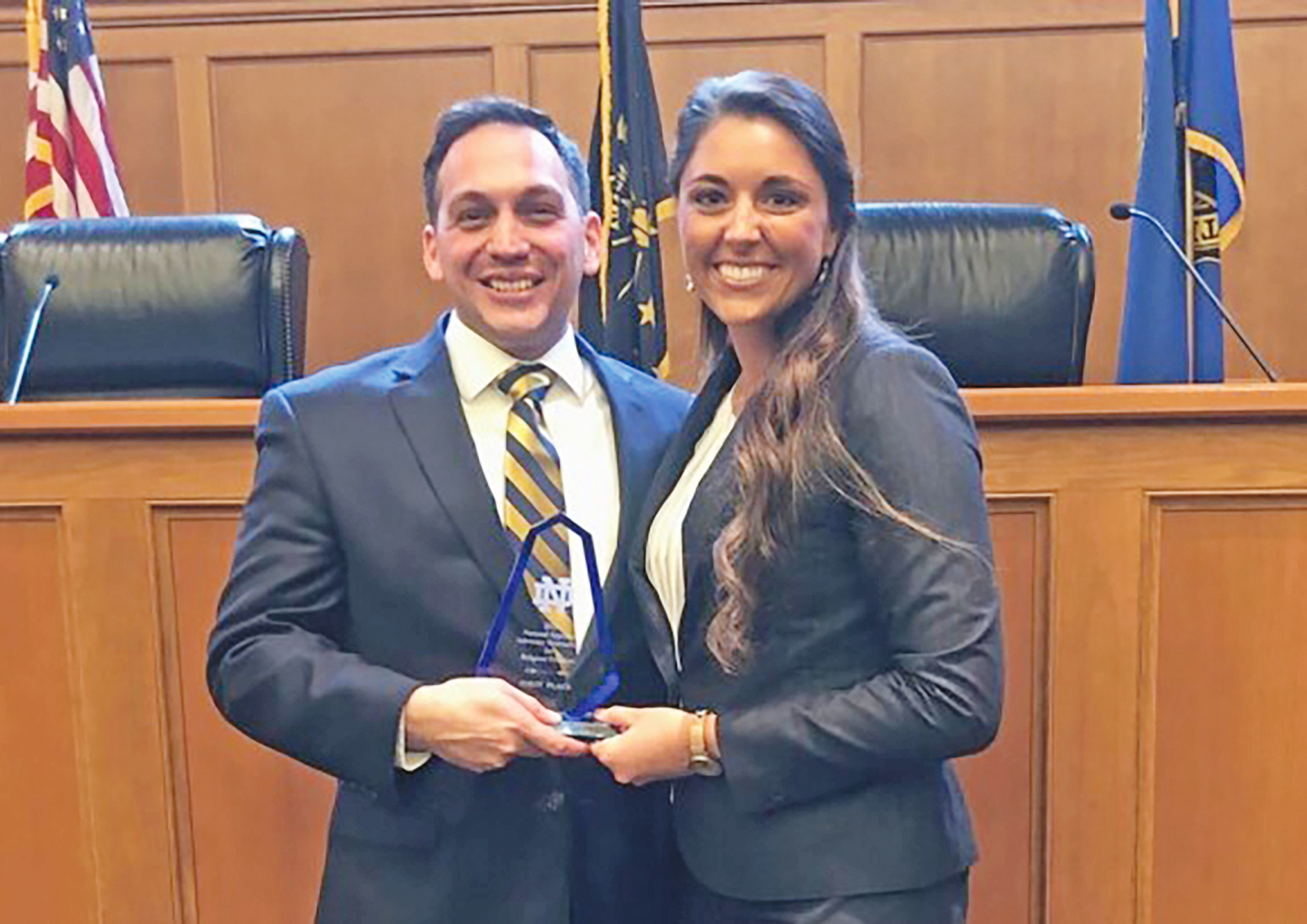 Xavier Romero and Summer Robbins of Florida Coastal School of Law show off the trophy after their team won the Notre Dame Religious Freedom National Moot Court Competition.
