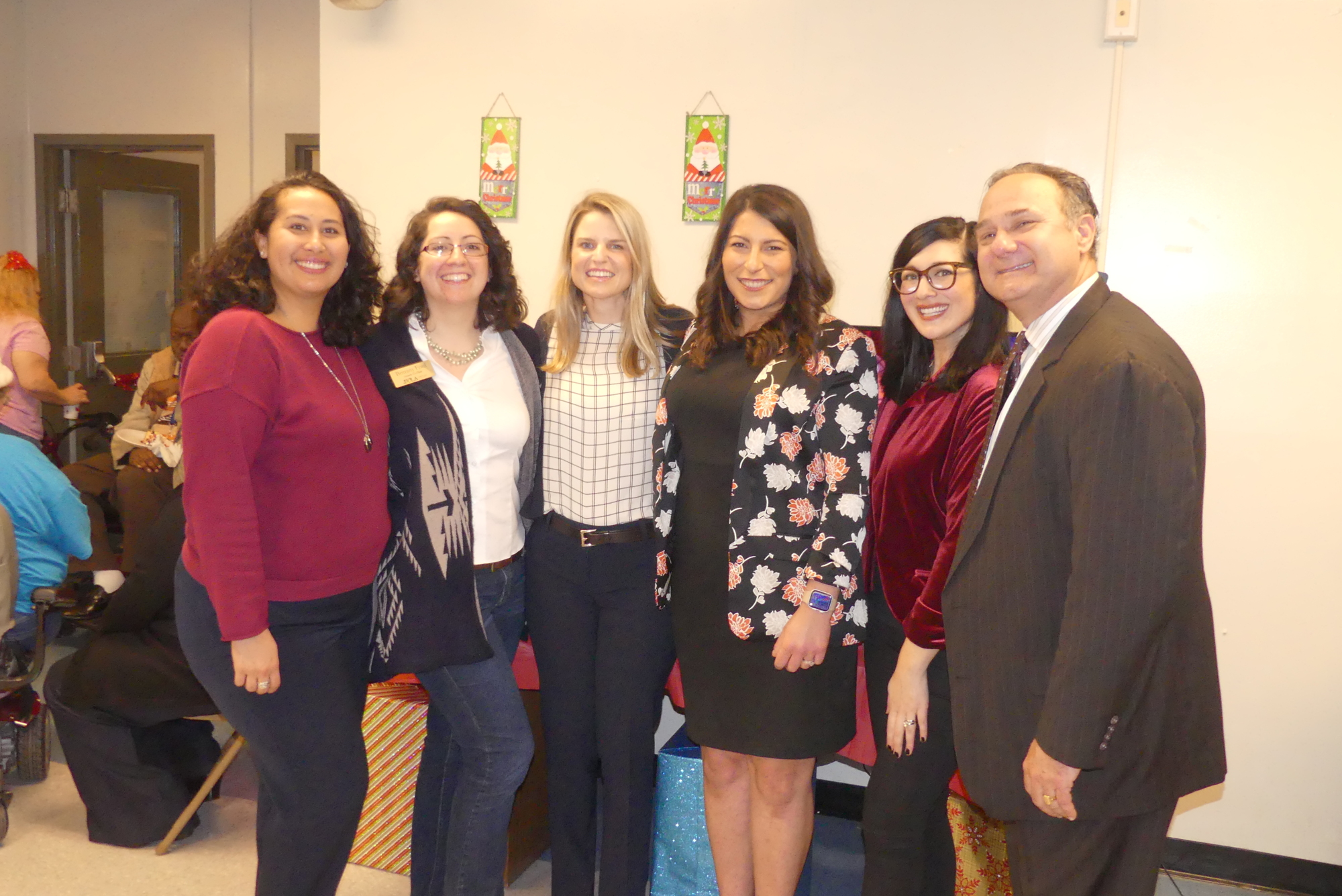 From left, Sarah Mannion, Brittany Ford, Lauren Johnston, Jamie Karpman, Francine Palmeri and Duval County Judge Gary Flower. Flower and JWLA helped donate 250 gifts at the Cathedral Towers senior supportive living facility.