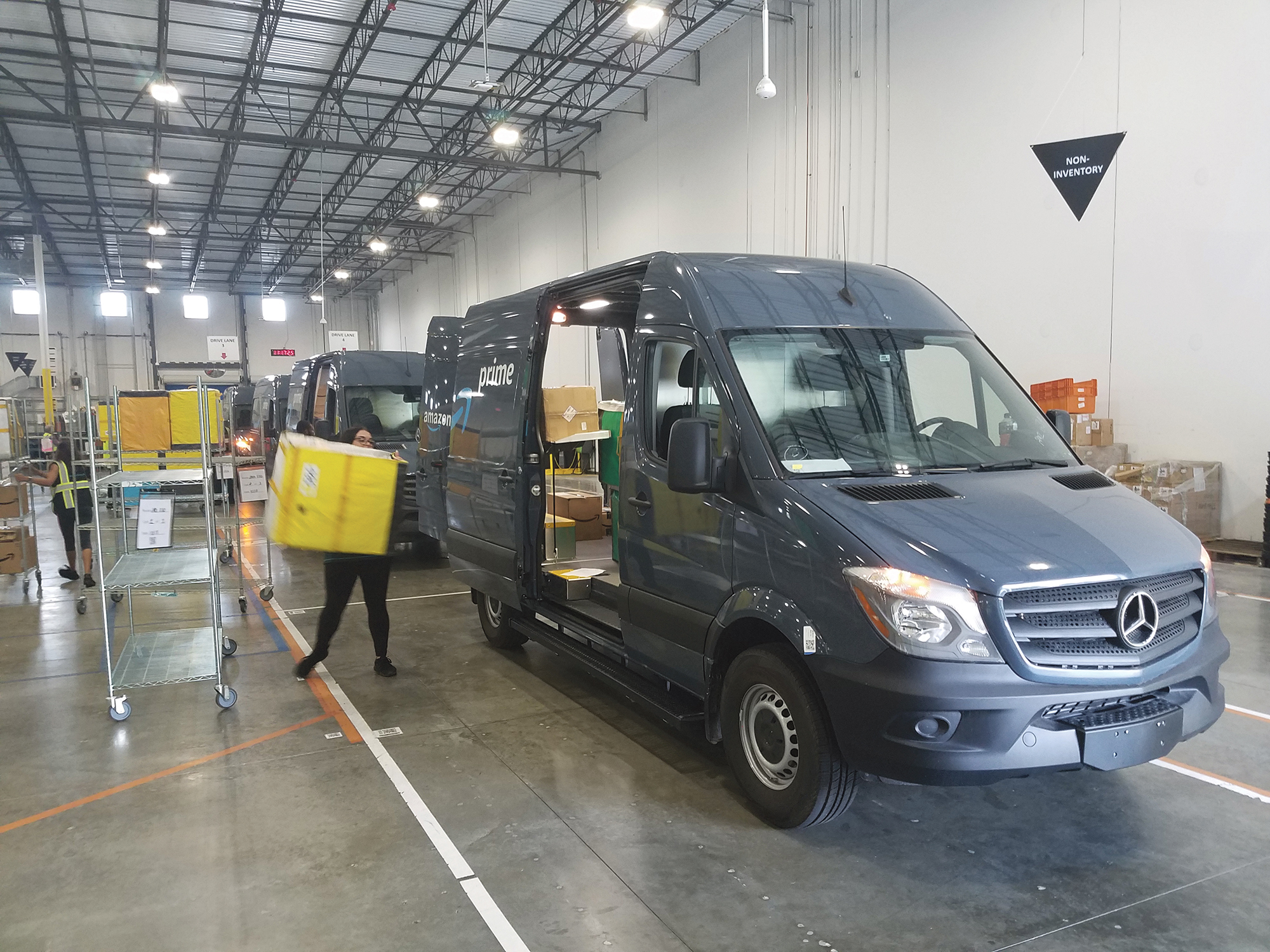 Delivery drivers load packages at the Amazon sortation center in North Jacksonville.