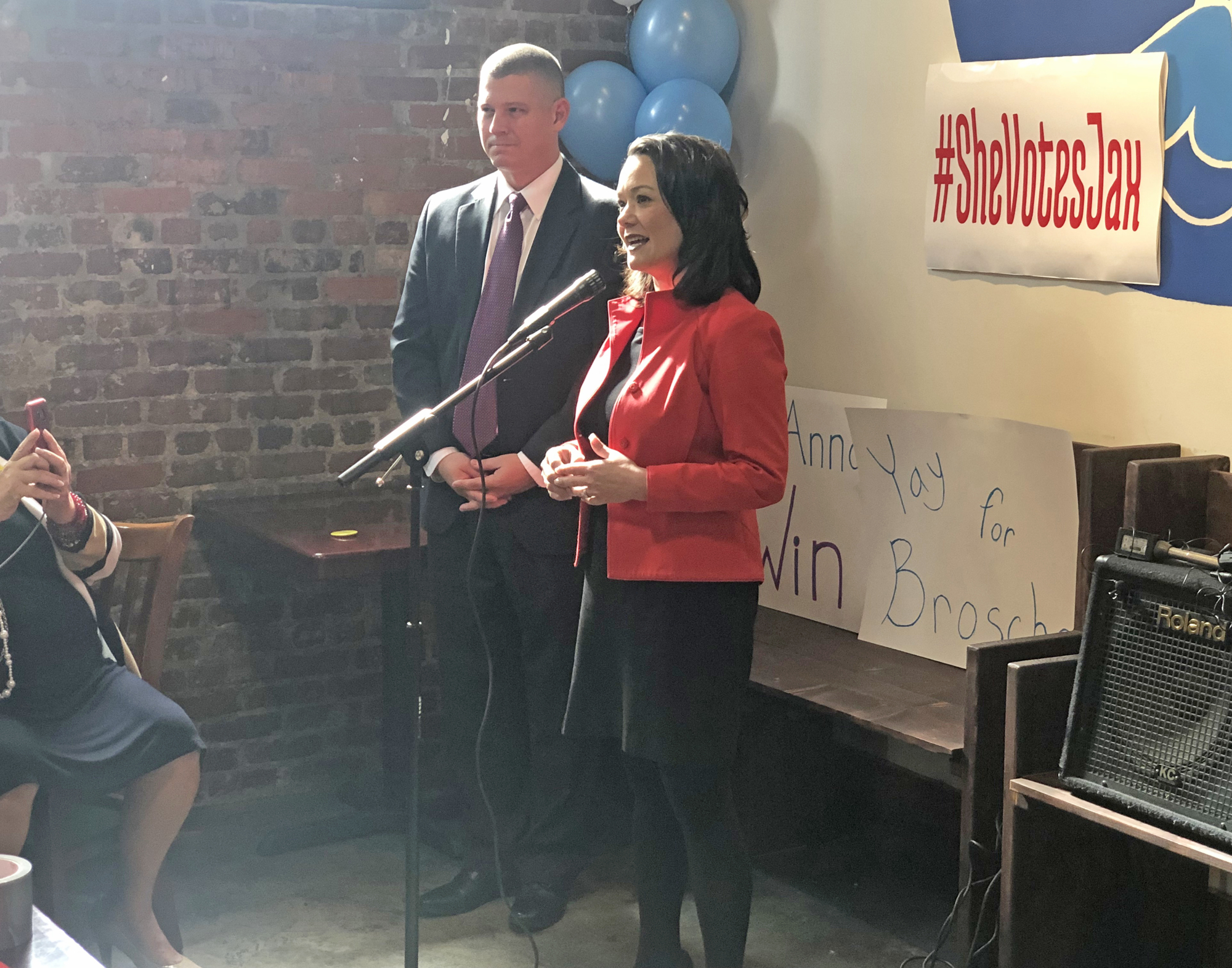 City Council member Anna Lopez Brosche announces her bid for mayor while her husband, Dave, watches.