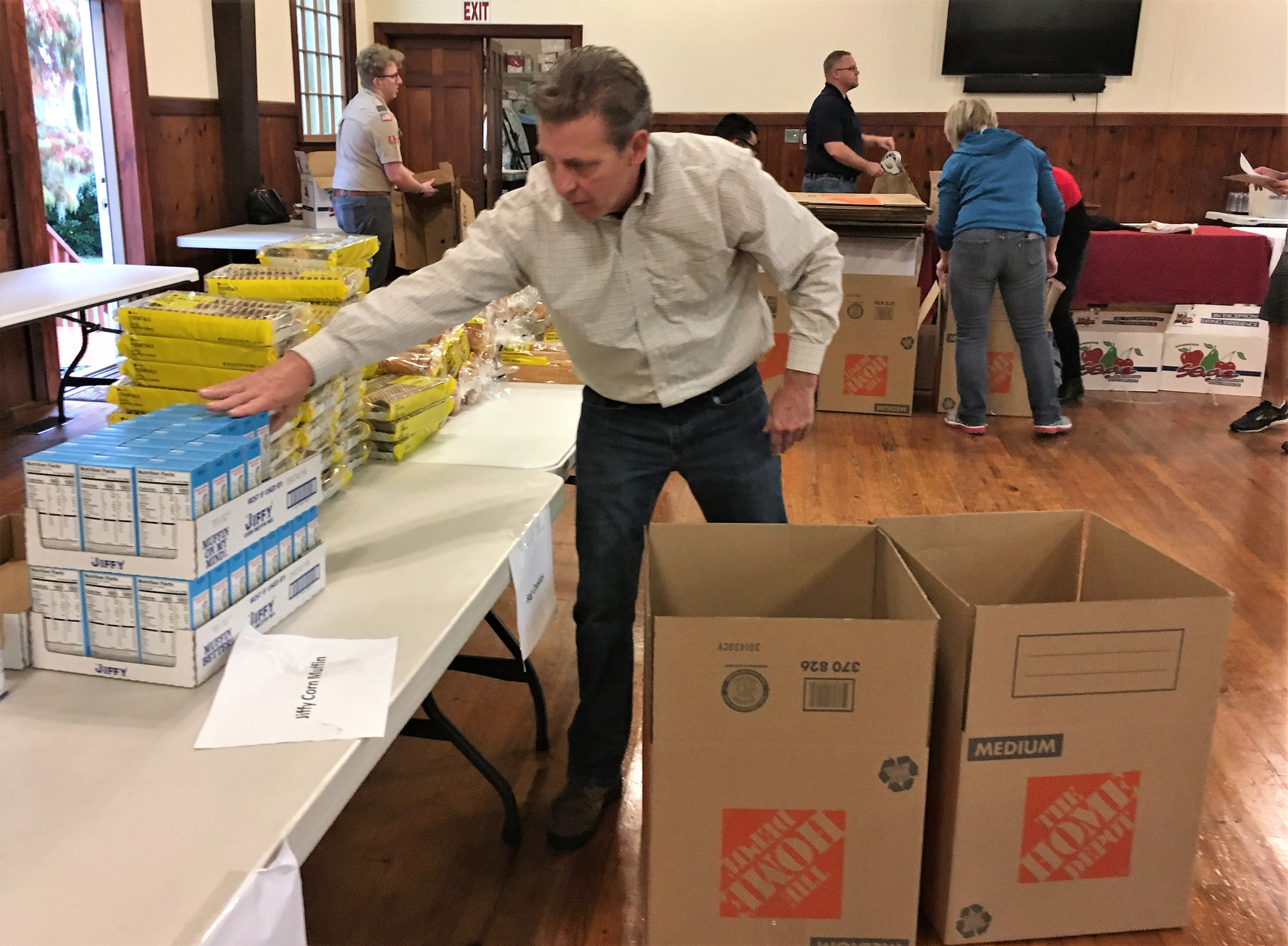Bill Garrison, executive officer of the Northeast Florida Builders Association, helps pack food boxes that were part of the holiday dinner giveaway at St. Mary’s Church in Green Cove Springs.