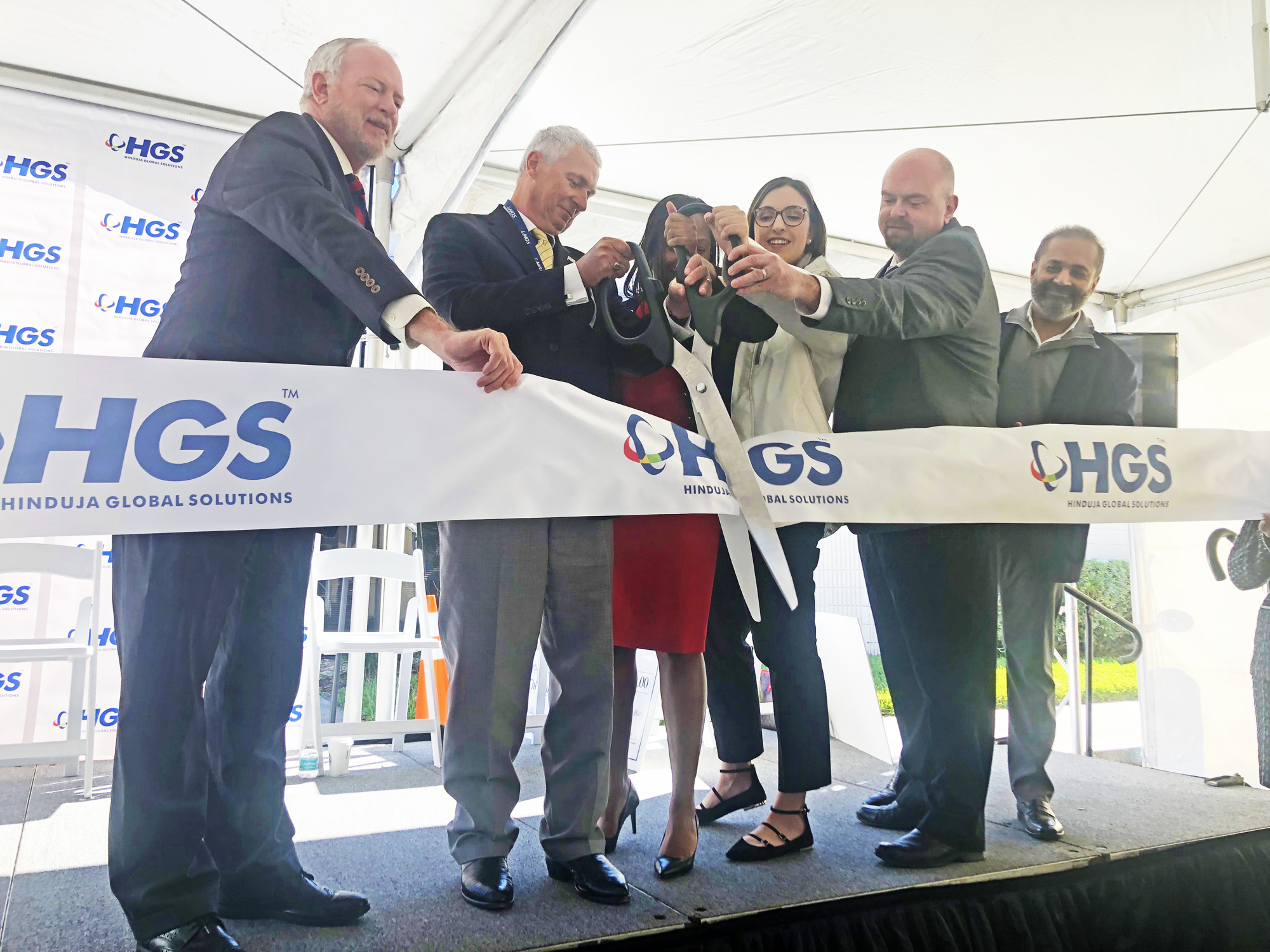 From left, City Council President Aaron Bowman and HGS North American President Tim Schuh take part in a ribbon-cutting ceremony Friday.