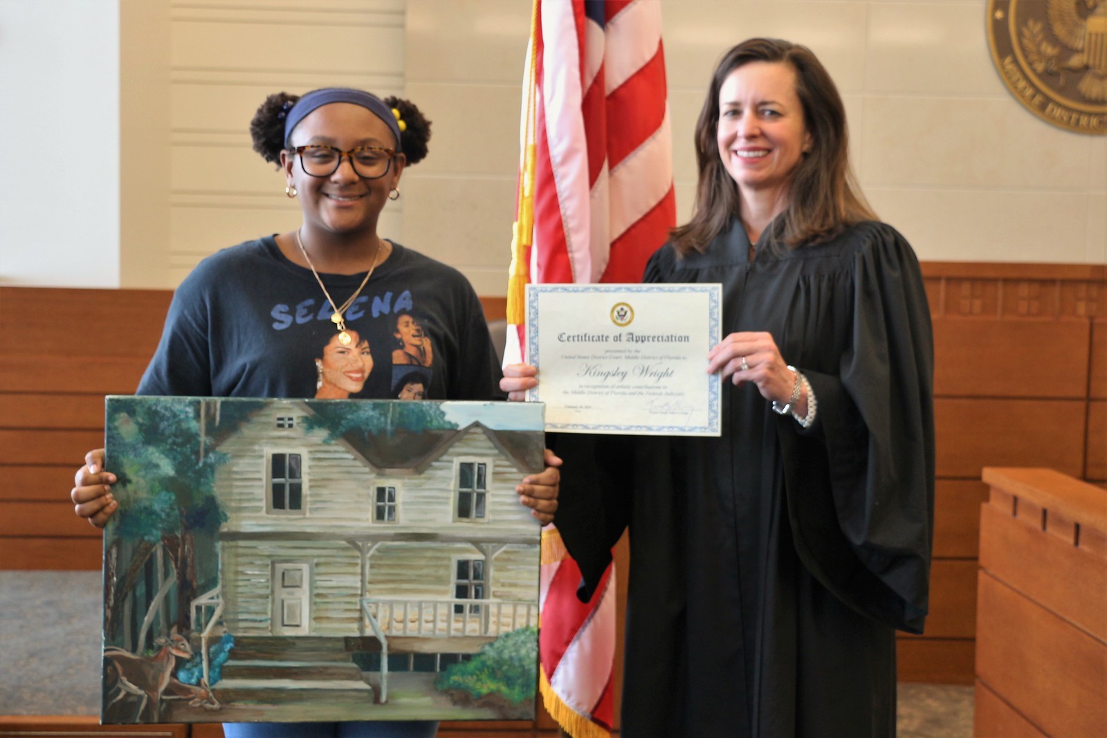 LaVilla School of the Arts student Kingsley Wright, left,  and U.S. Magistrate Judge Patricia Barksdale with a painting Wright donated to the U.S. District Court in Jacksonville.