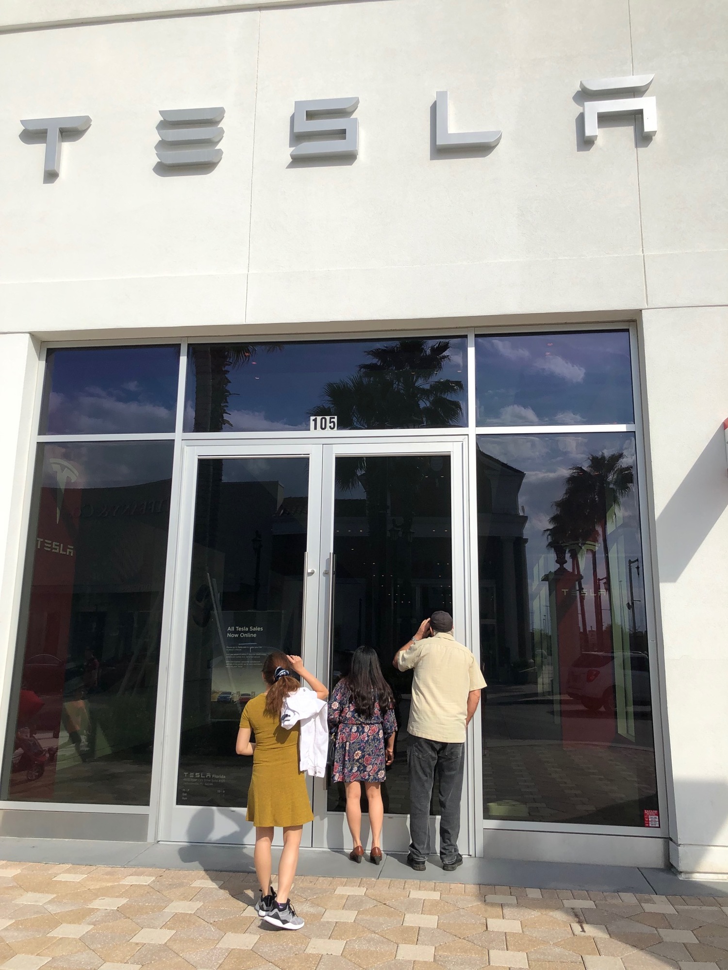 Tesla removed its electric cars and shut the doors at its former showroom at St. Johns Town Center.