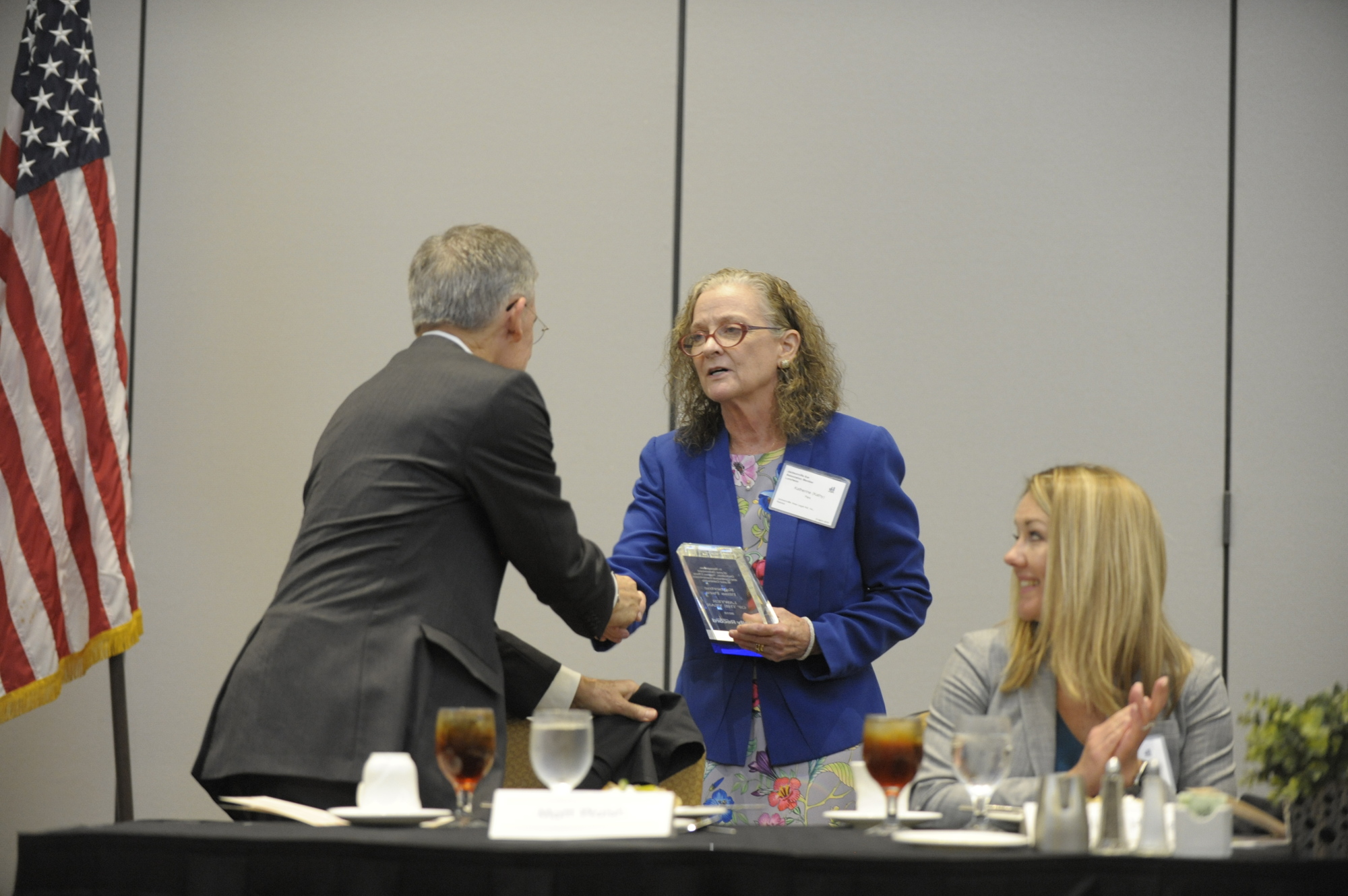 Kathy Para receives the Lawyer of the Year award from Jacksonville Daily Record Publisher Matt Walsh.