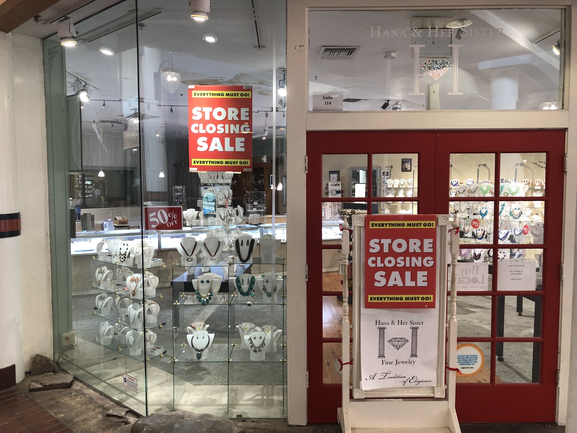Store closing signs are displayed in the window of Hana & Her Sister jewelry store at The Jacksonville Landing.
