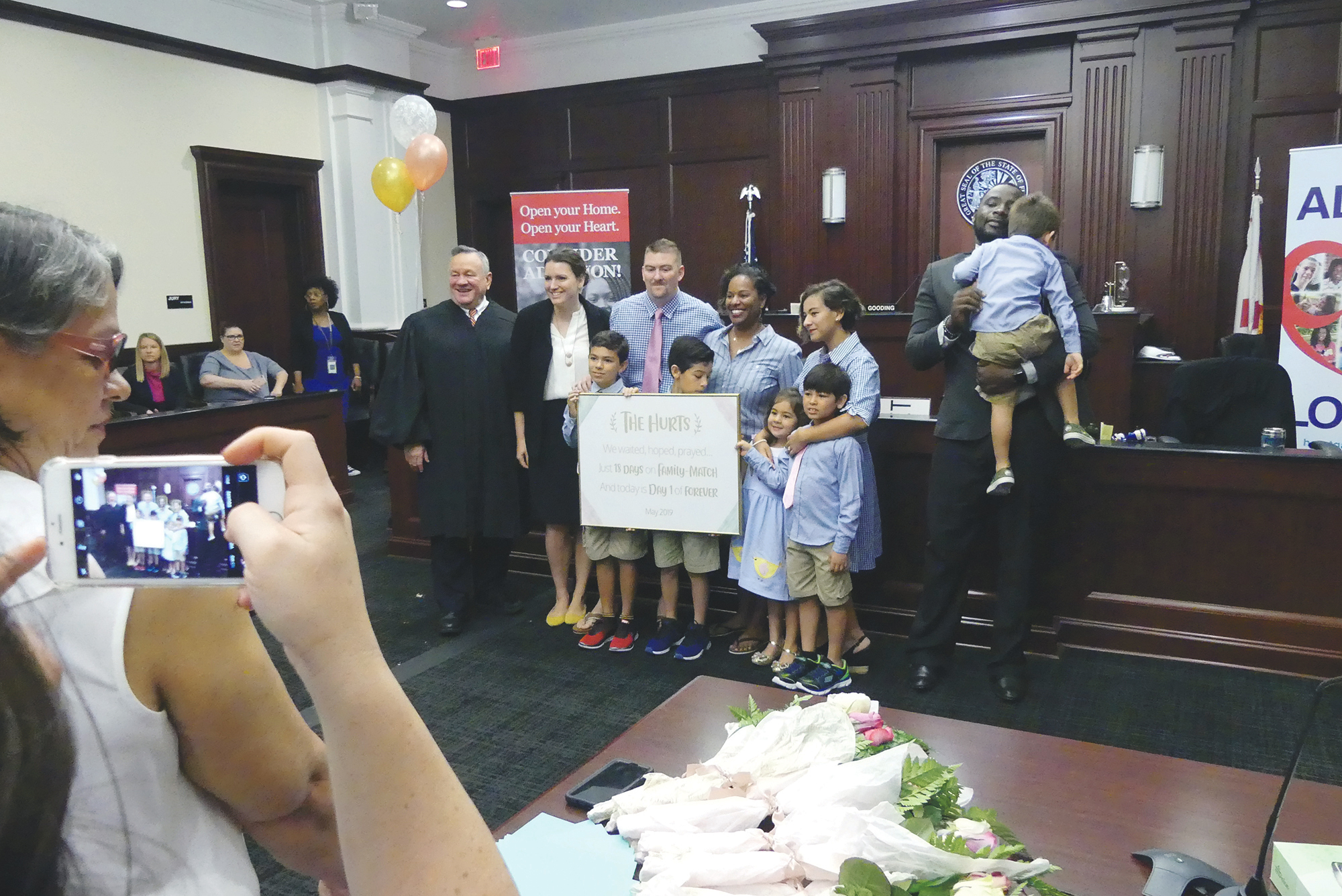 Circuit Judge David Gooding presides over the adoptions.