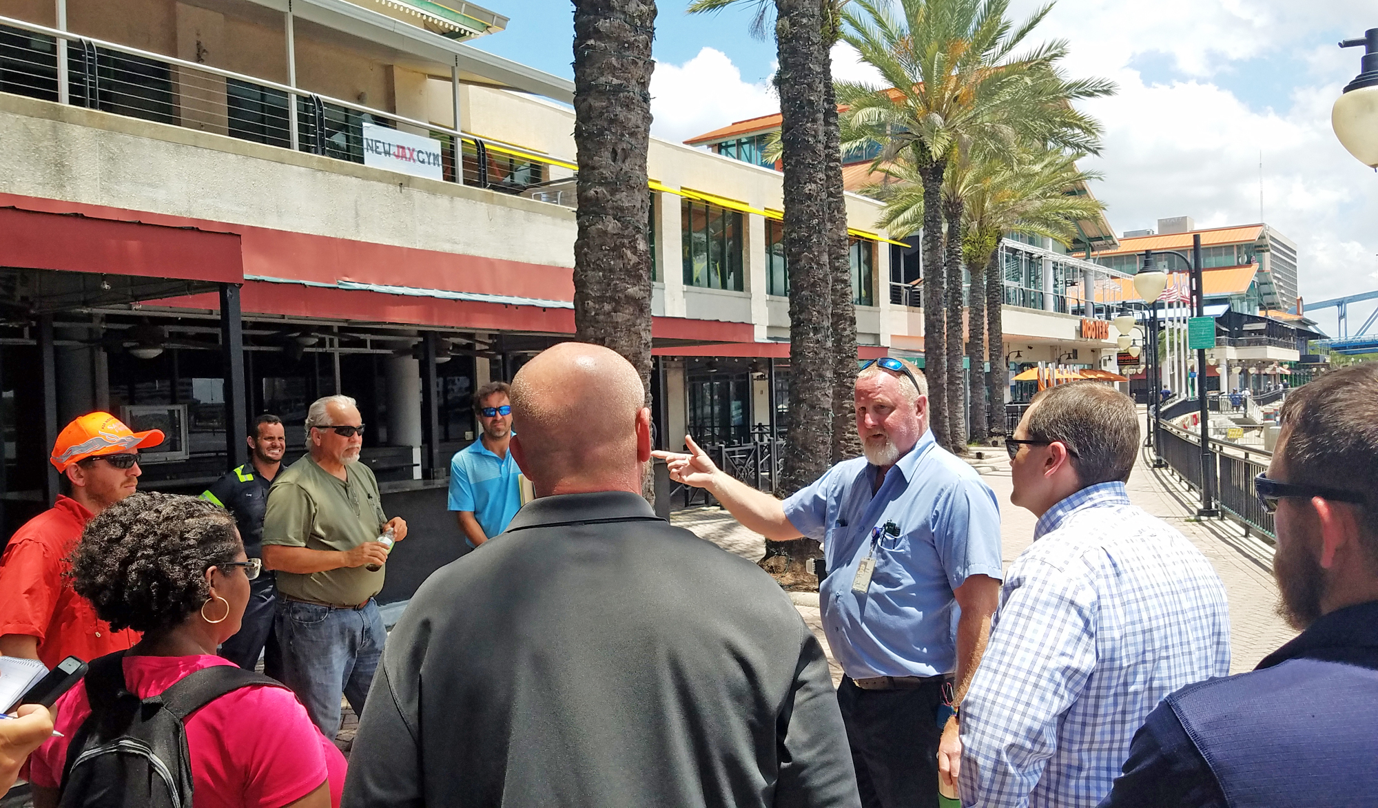 Bill Miller, a mechanical engineer with the city, explains to the demolition contractors that the palm trees on the Riverwalk are to remain.
